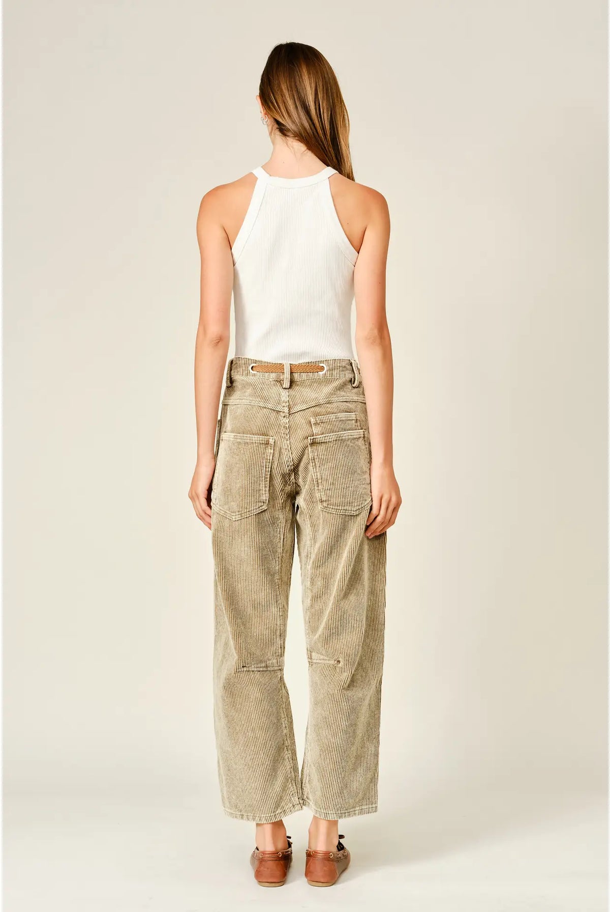 Women’s camel corduroy trousers featuring a subtle barrel fit, utility patch pockets, belt loops, and a rope tie waist.