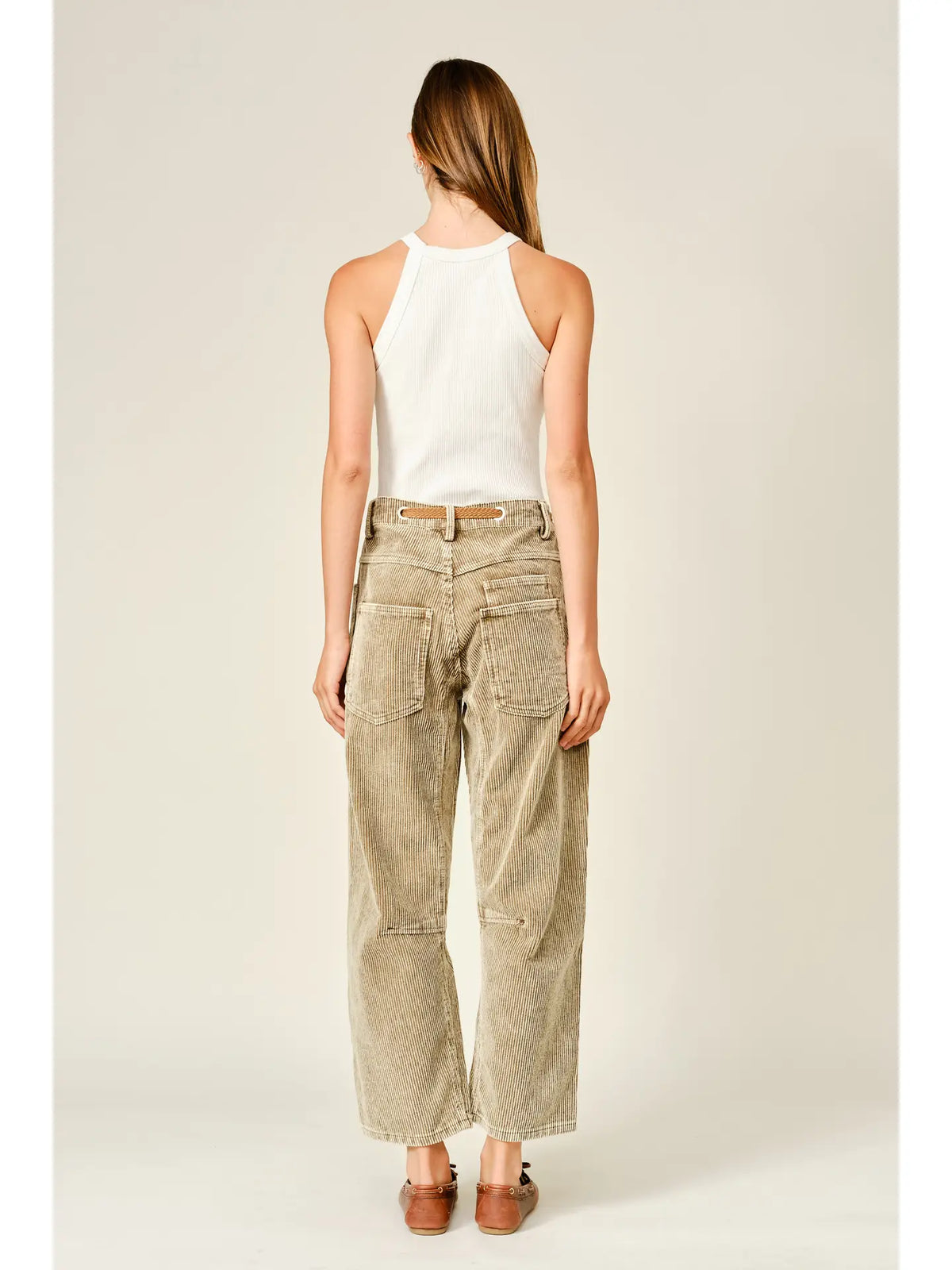 Women’s camel corduroy trousers featuring a subtle barrel fit, utility patch pockets, belt loops, and a rope tie waist.