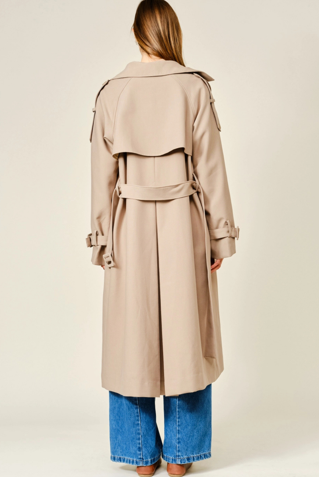 Monroe relaxed longline trench coat in soft, textured fabric, featuring a layered neckline, double-button front closure, and adjustable waist belt for a polished, sophisticated look.
