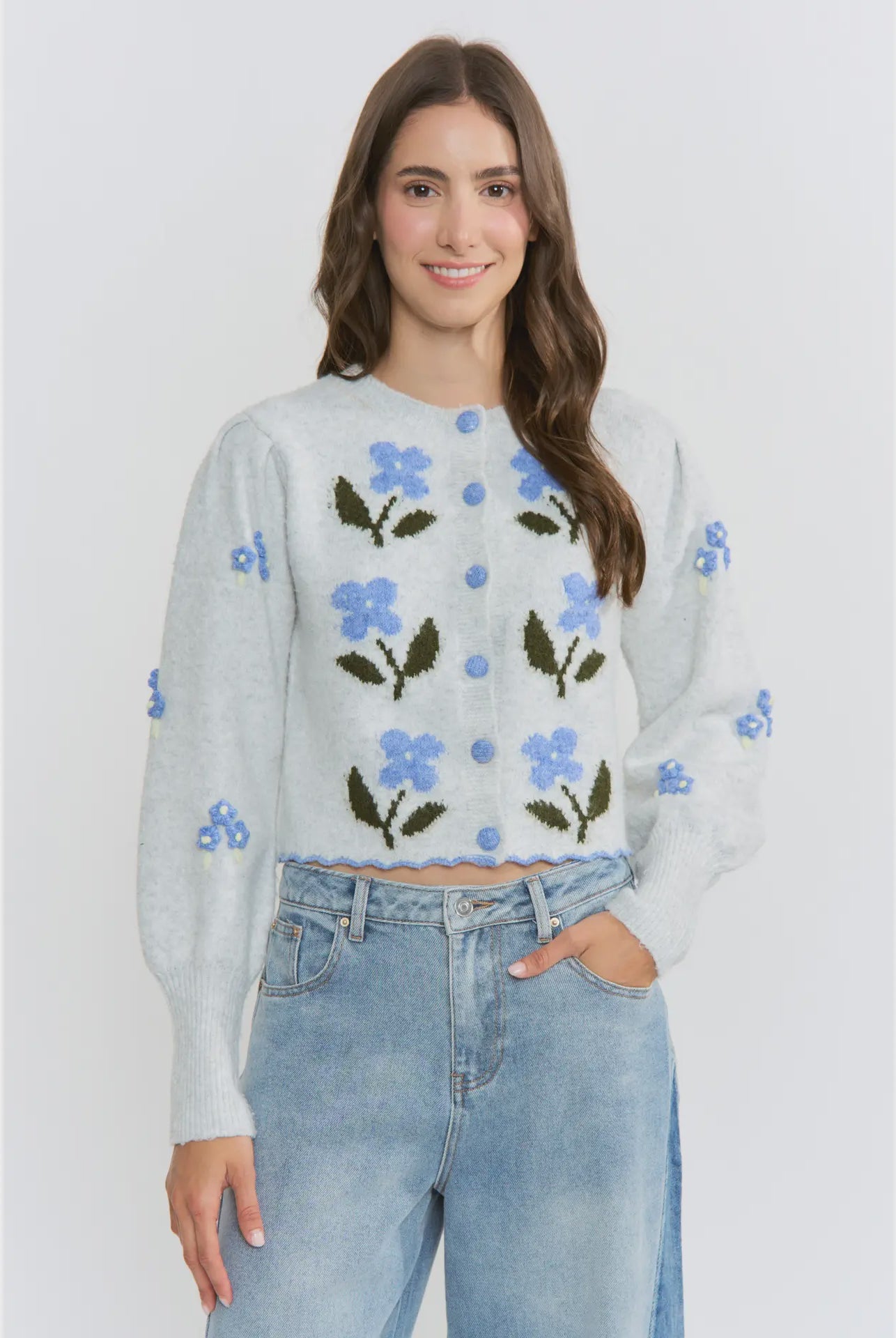 The Amelie Floral Cardigan in light grey with delicate blue floral embroidery and green stem details.