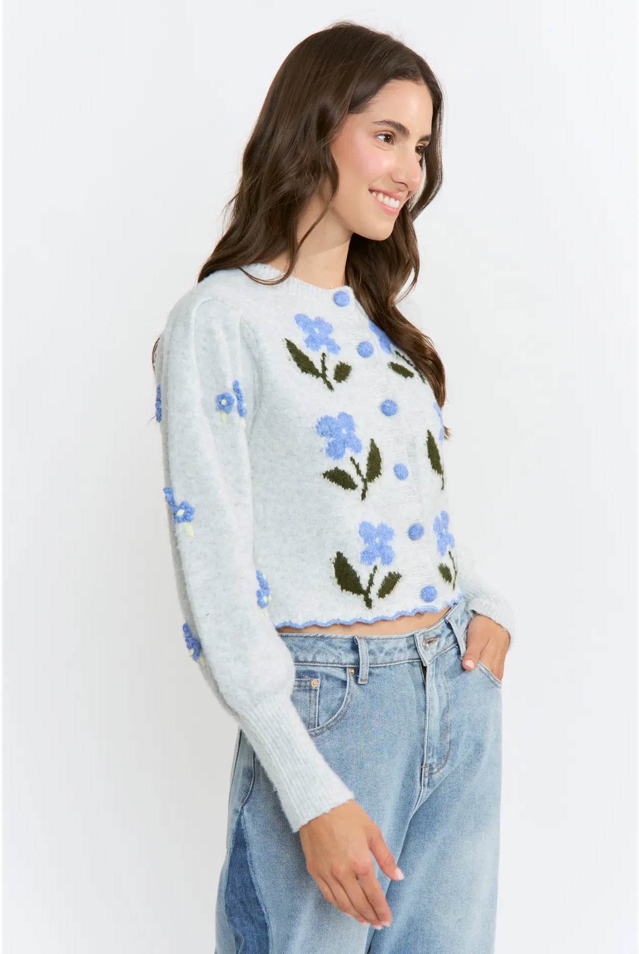 The Amelie Floral Cardigan in light grey with delicate blue floral embroidery and green stem details.