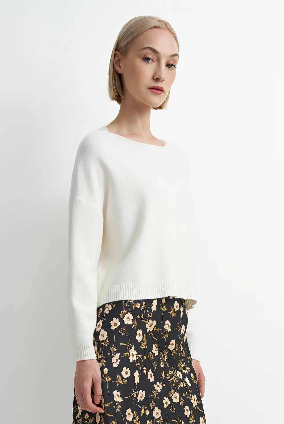 Soft cream crewneck sweater with a relaxed fit, cozy knit texture, and clean, classic silhouette.