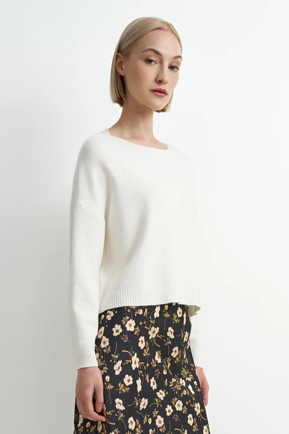 Soft cream crewneck sweater with a relaxed fit, cozy knit texture, and clean, classic silhouette.
