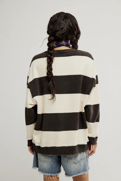 woman wearing black and white striped oversized crewneck