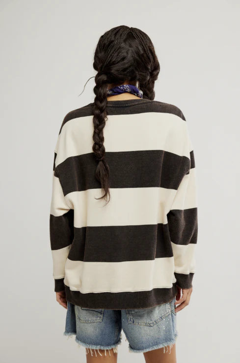 woman wearing black and white striped oversized crewneck