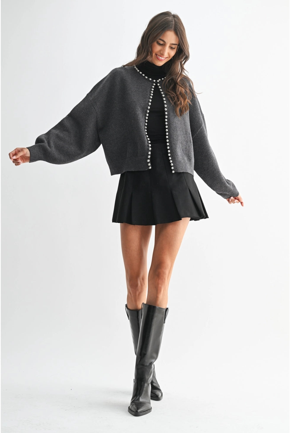 The Celeste Cardigan in a soft knit fabric, featuring delicate pearl detailing, a button-front design, and an elegant feminine silhouette.