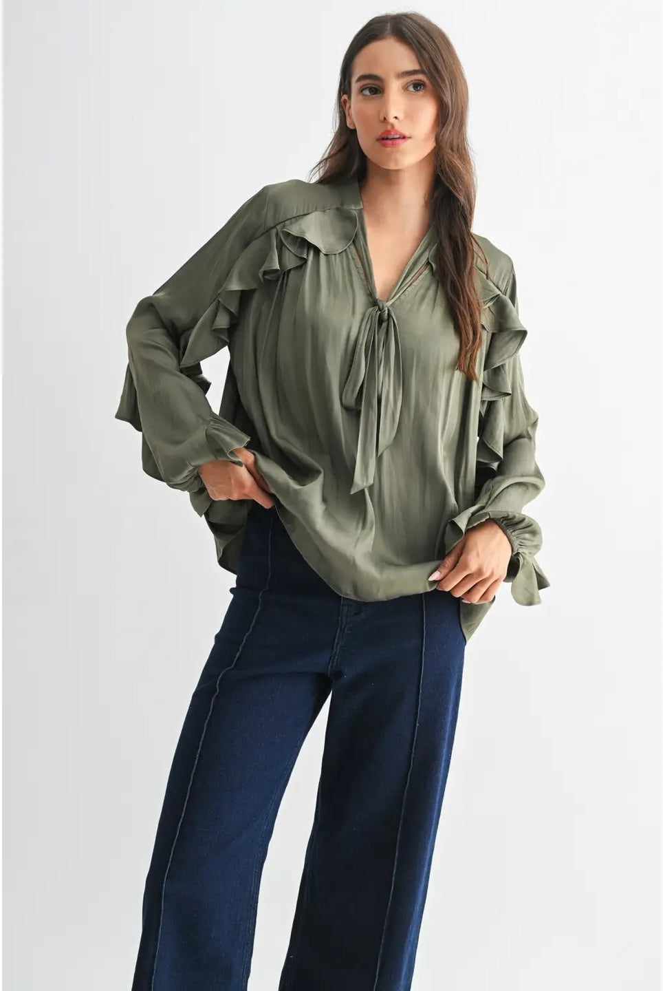 The Juliette Ruffle Blouse in olive green, featuring delicate ruffle detailing and a soft, silky finish.