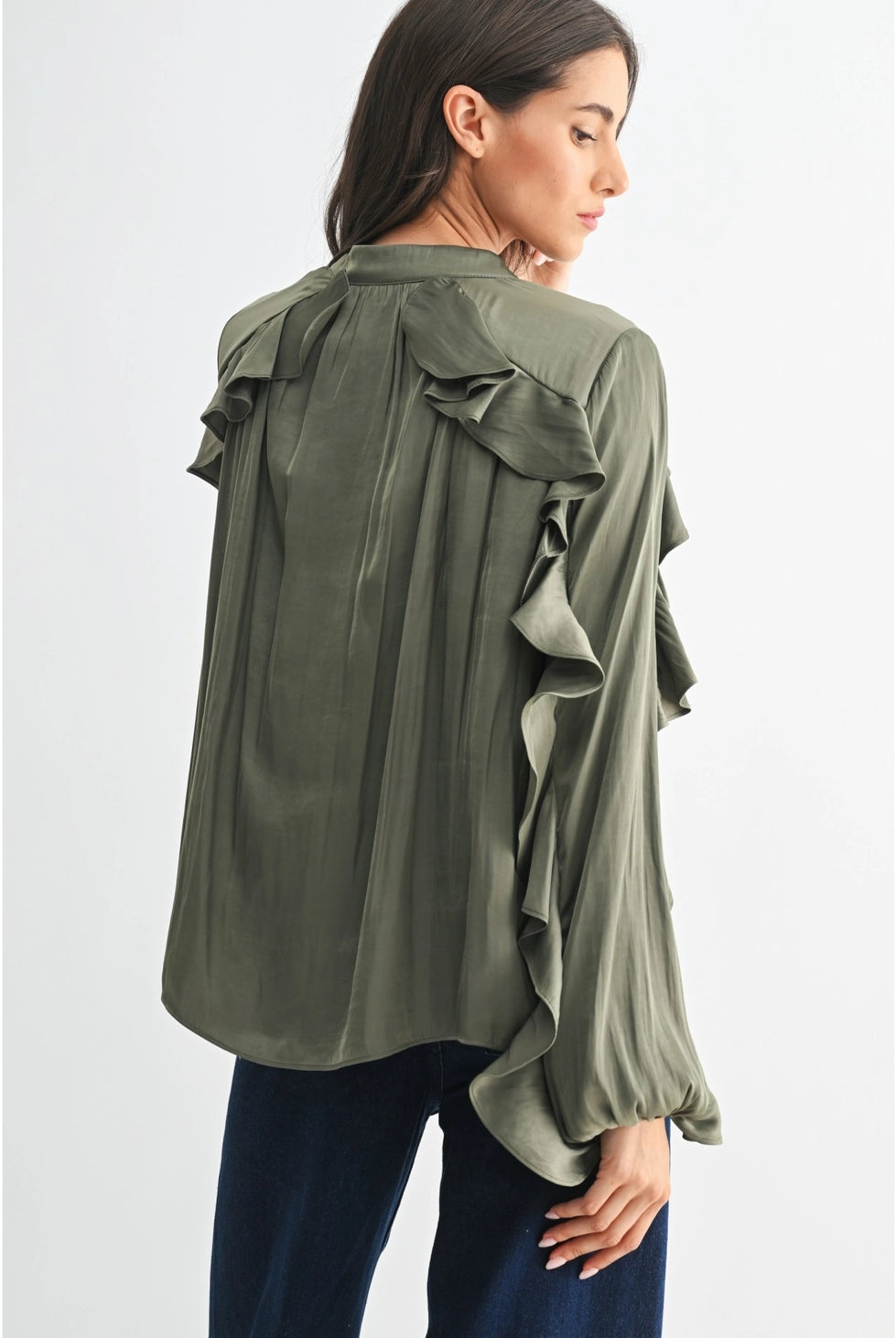 The Juliette Ruffle Blouse in olive green, featuring delicate ruffle detailing and a soft, silky finish.