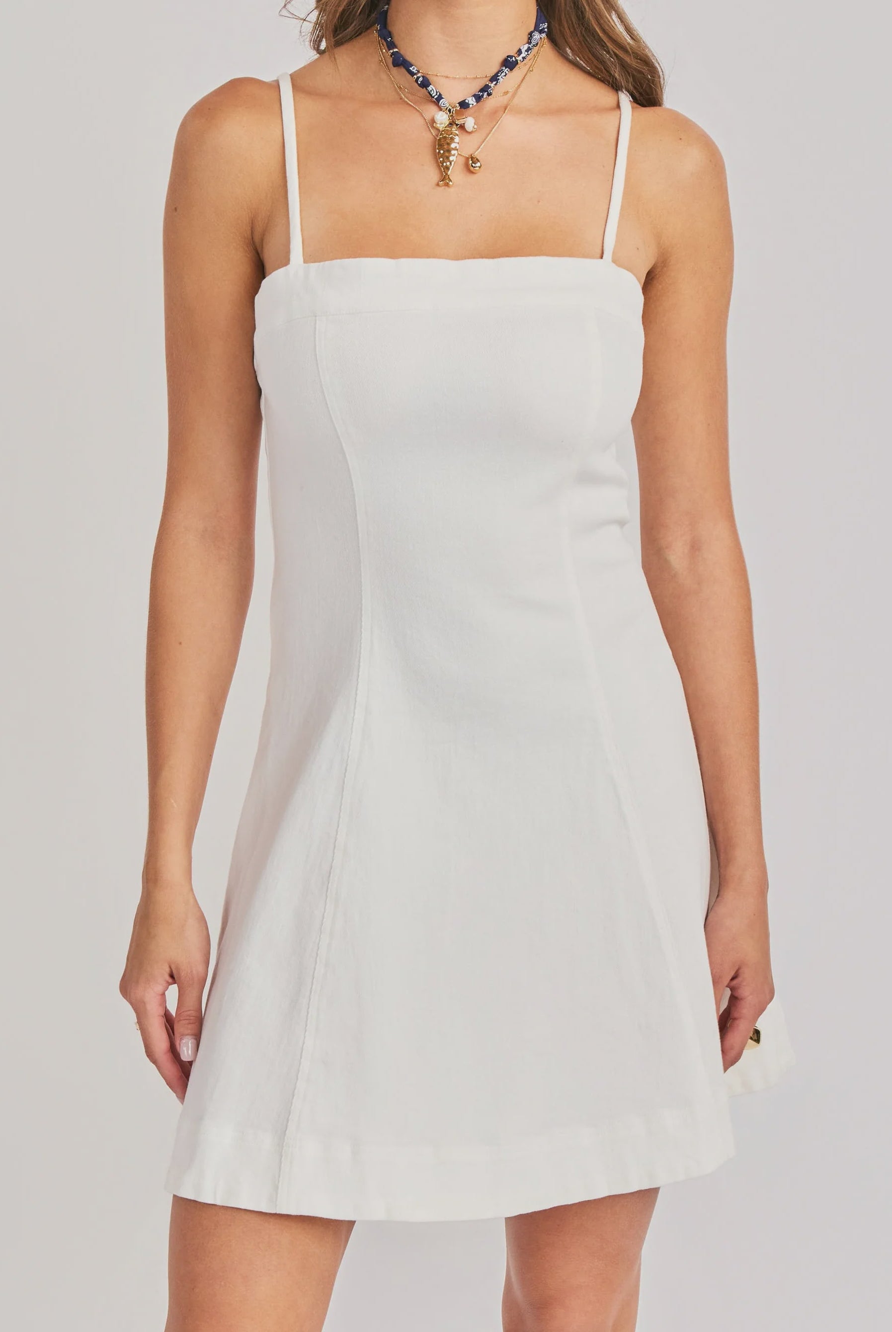 woman wearing white mini dress with spaghetti straps