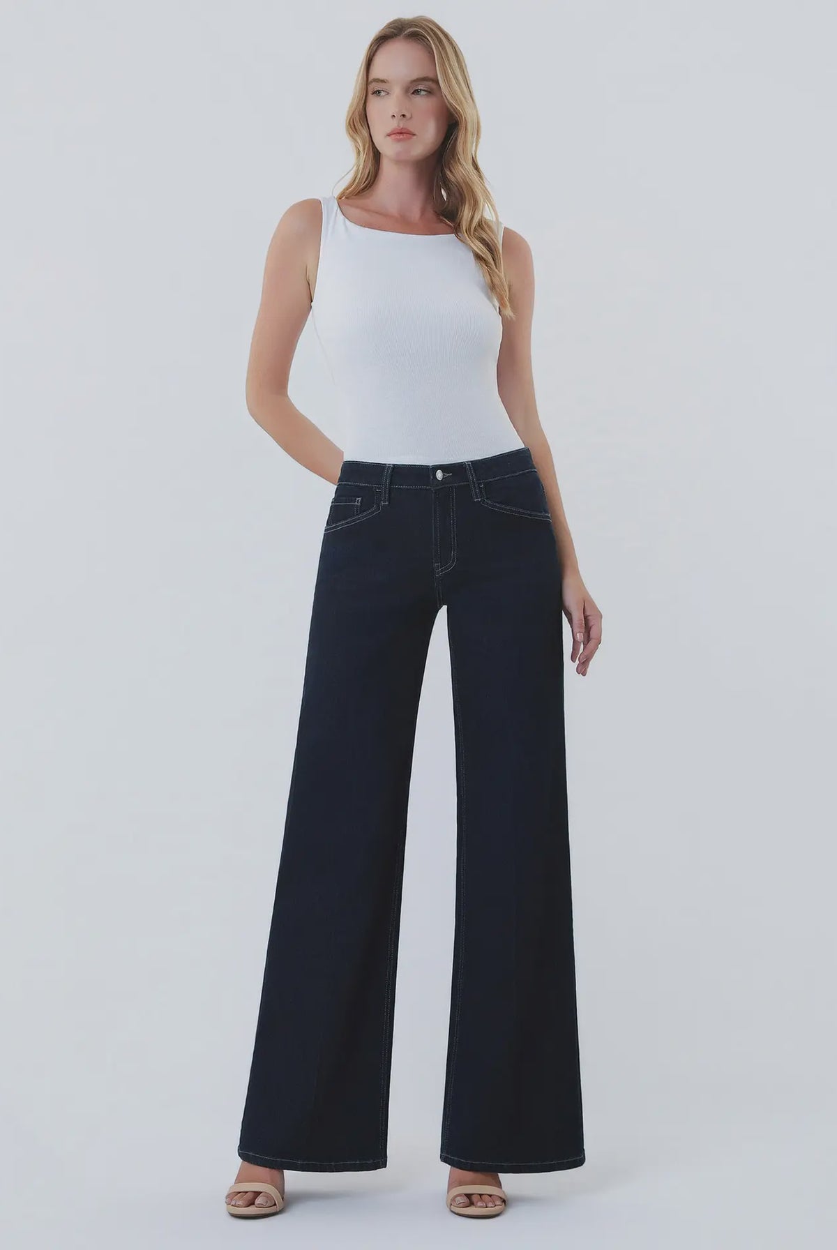 Dark wash wide-leg jeans featuring a mid-rise waist, trouser-inspired front crease, classic five-pocket design, finished hem, and full-length silhouette.