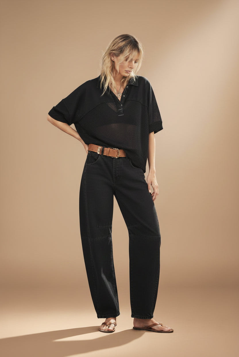 woman wearing washed black mid rise barrel jeans in an ankle length