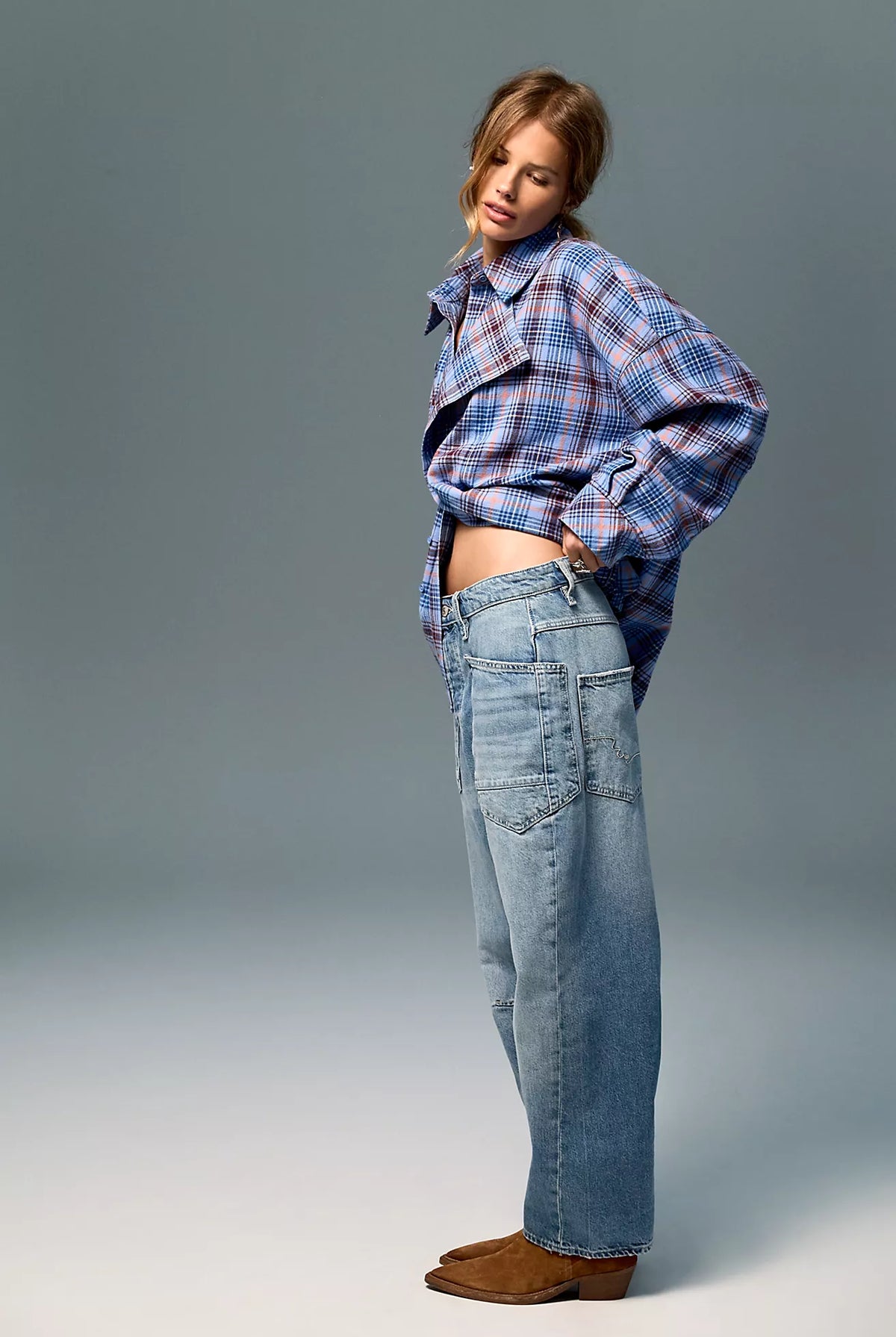 Low-rise barrel-leg pants in rigid denim with a relaxed, slouchy fit, curved leg shape, oversized patch pockets, button-fly closure, and finished hem.