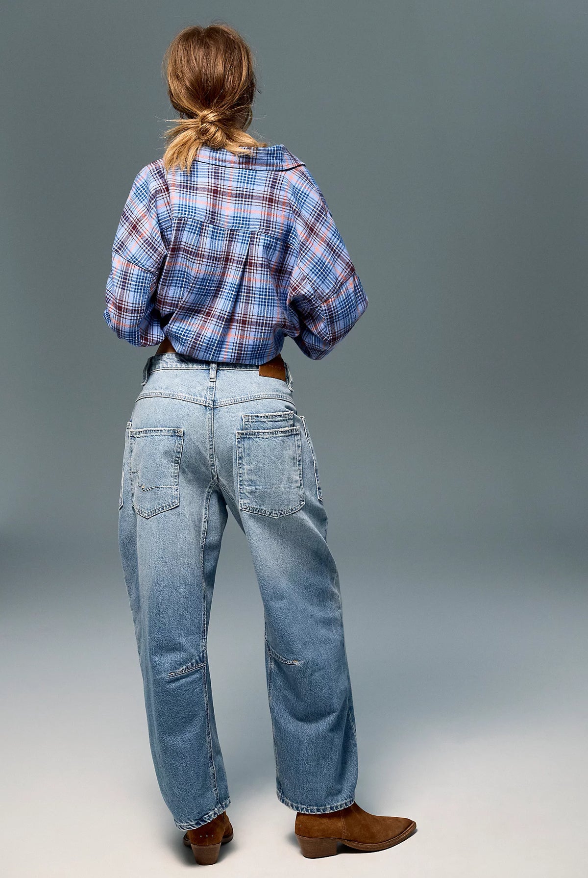 Low-rise barrel-leg pants in rigid denim with a relaxed, slouchy fit, curved leg shape, oversized patch pockets, button-fly closure, and finished hem.