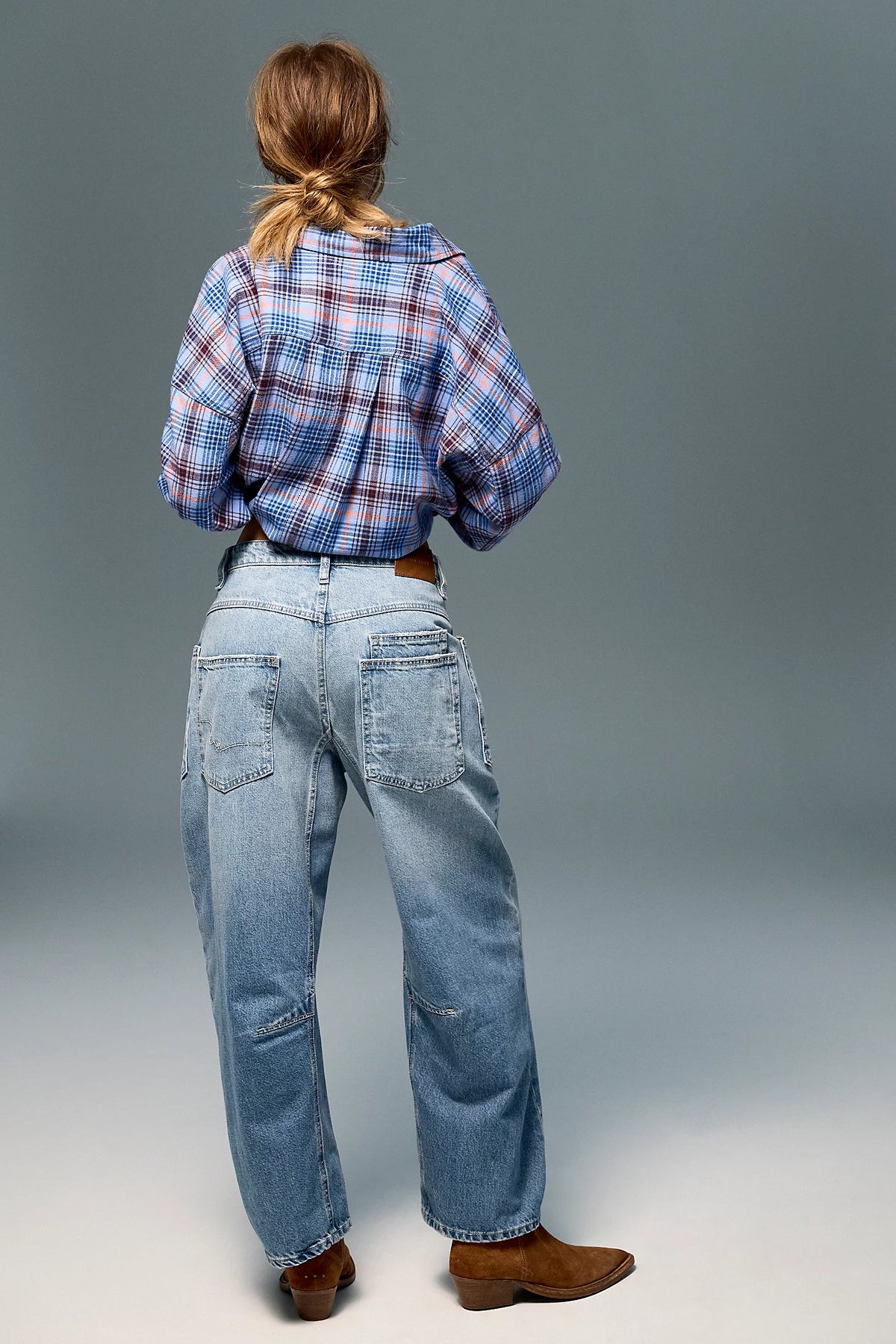 Low-rise barrel-leg pants in rigid denim with a relaxed, slouchy fit, curved leg shape, oversized patch pockets, button-fly closure, and finished hem.