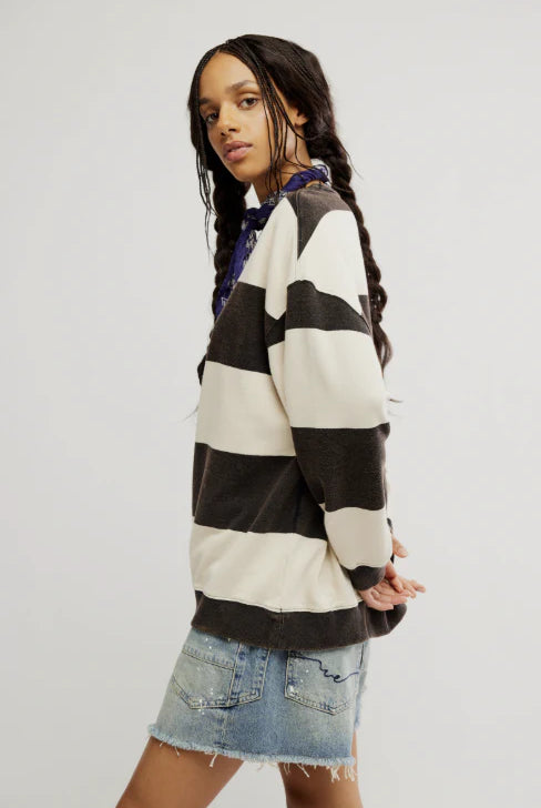 woman wearing black and white striped combo crewneck sweater