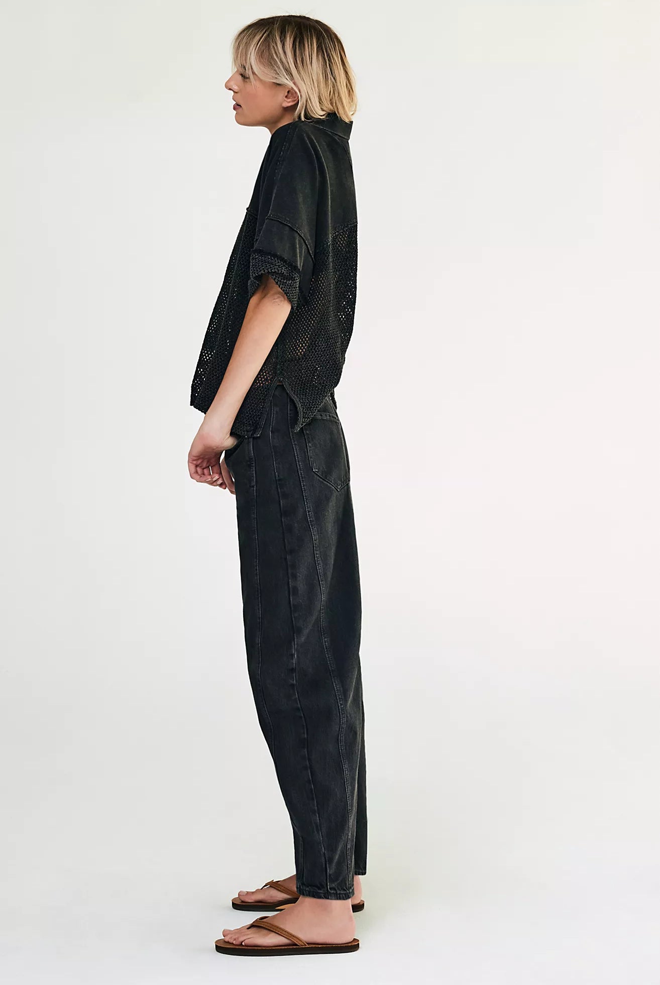 woman wearing washed black mid rise barrel jeans in an ankle length