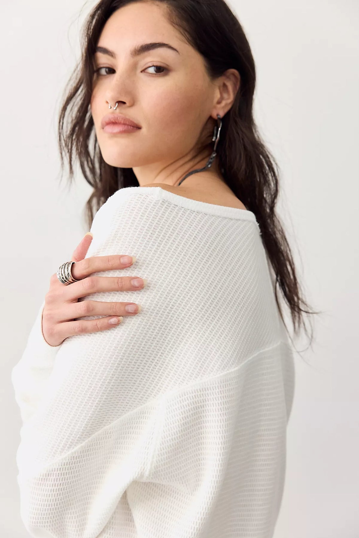 Thermal long-sleeve top featuring a flattering boat neckline, relaxed dolman sleeves, textured cotton-blend fabrication, seamed detailing, and elongated cuffs.