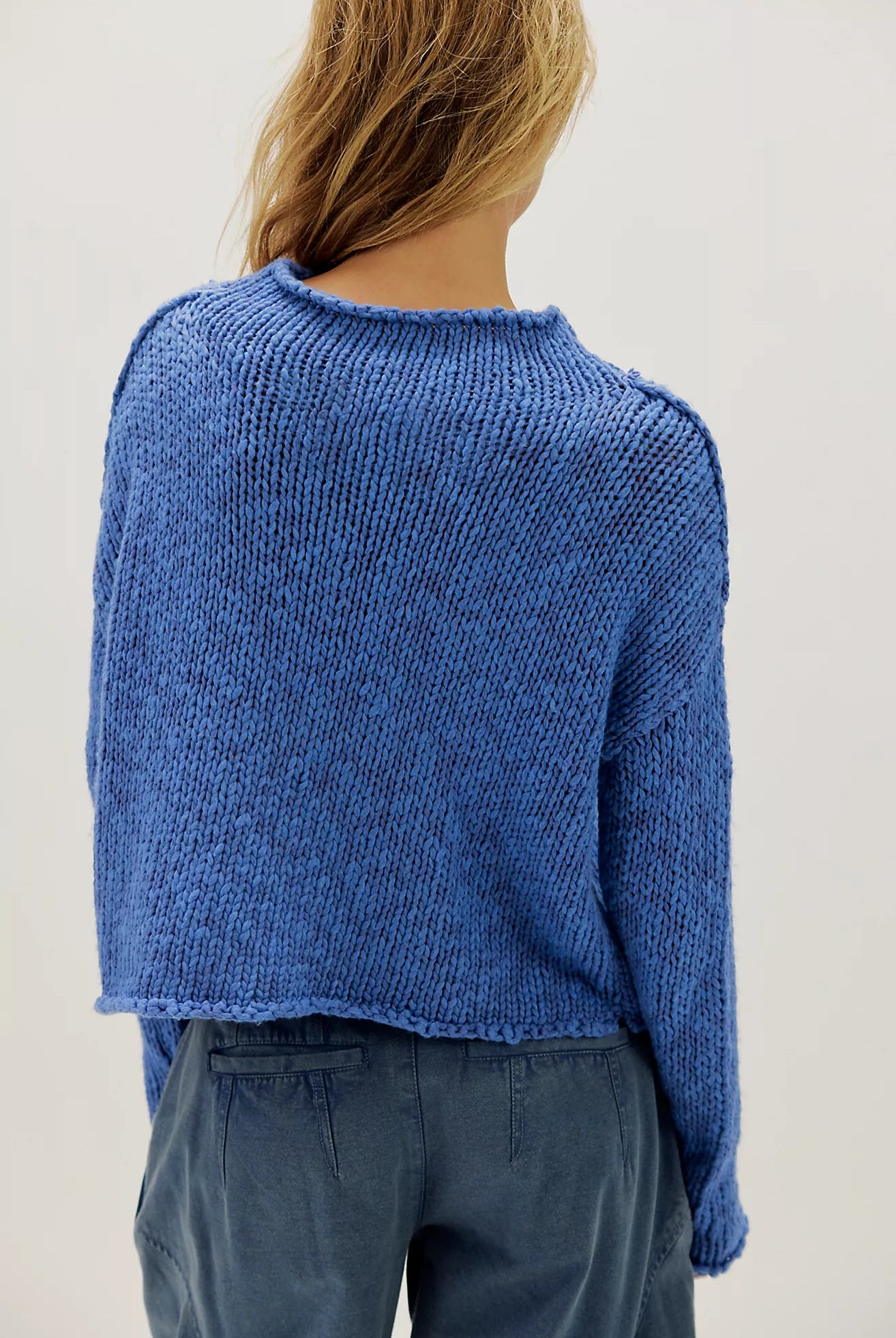 Peri Blue cotton knit sweater with a relaxed boxy fit, rolled neckline, dropped shoulders, and long sleeves.