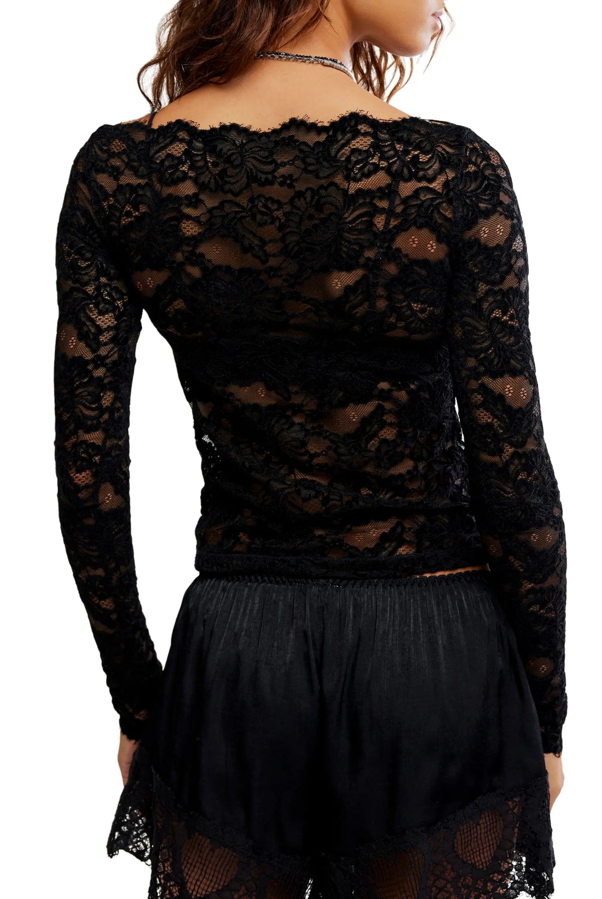 Sheer floral lace long-sleeve top with a fitted silhouette, boat neckline, ribbed trim, and added stretch for a comfortable, body-skimming fit. Base layer sold separately.