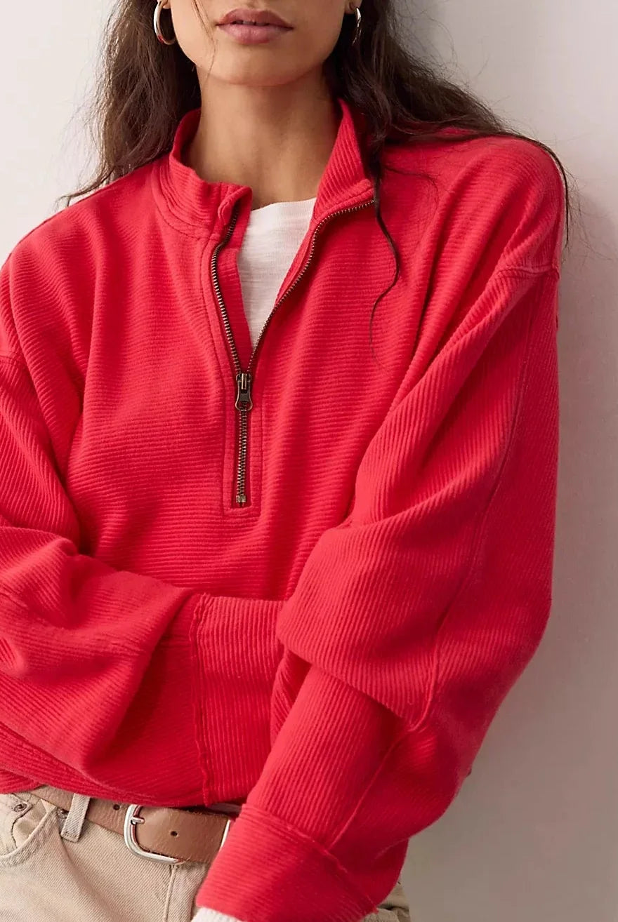 Soft 100% cotton quarter-zip pullover with a slightly cropped, boxy fit, dropped shoulders, long sleeves, and stand collar.