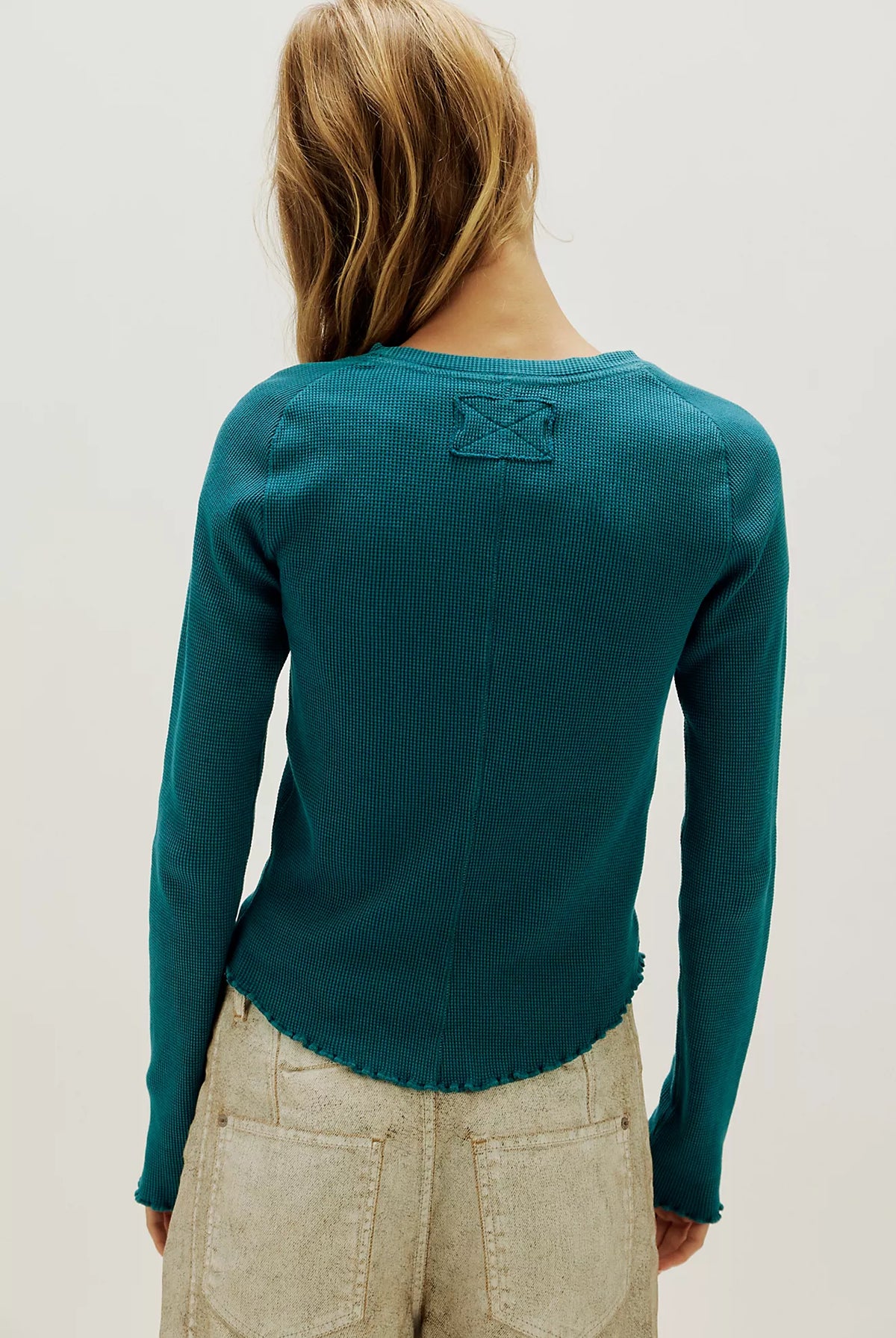 Waffle-knit long sleeve top in turqoise, featuring a relaxed slim fit, crew neckline, raglan sleeves, lettuce-edge trim, and subtle seam detailing.