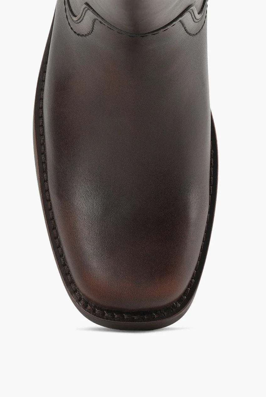 Brown Miranda 14 tall Western-inspired boots featuring a sleek vegan leather finish, square toe, 2-inch stacked block heel, and pull-on design with internal pull loops for easy wear.