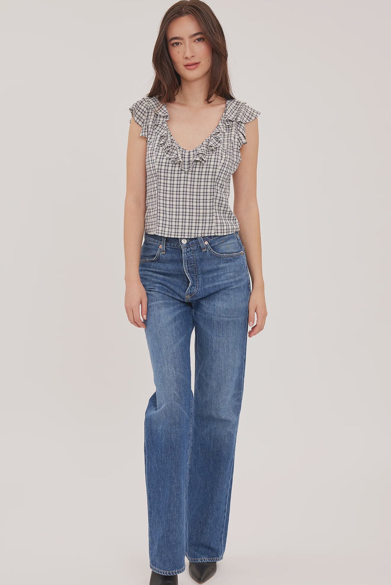 Women's black sleeveless tank top in a lightweight mini check fabric featuring a delicate flounce neckline, a relaxed fit, and a feminine silhouette.