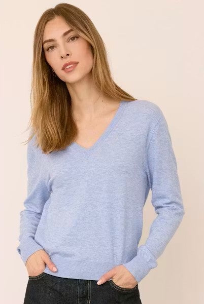 Woman wearing the Gentle Fawn Carina Sweater in Heather Blue, featuring a regular fit with a soft, lightweight knit in a classic light blue shade.