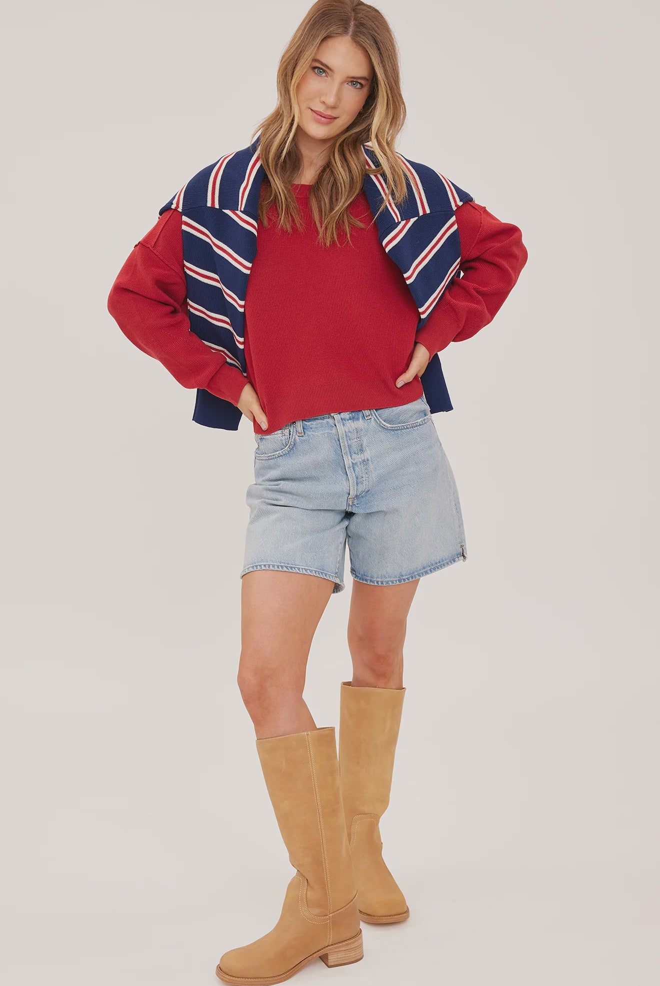 red oversized knit pullover sweater featuring a classic crew neckline, exposed seam detailing, side slits, and a soft textured half-cardigan stitch.