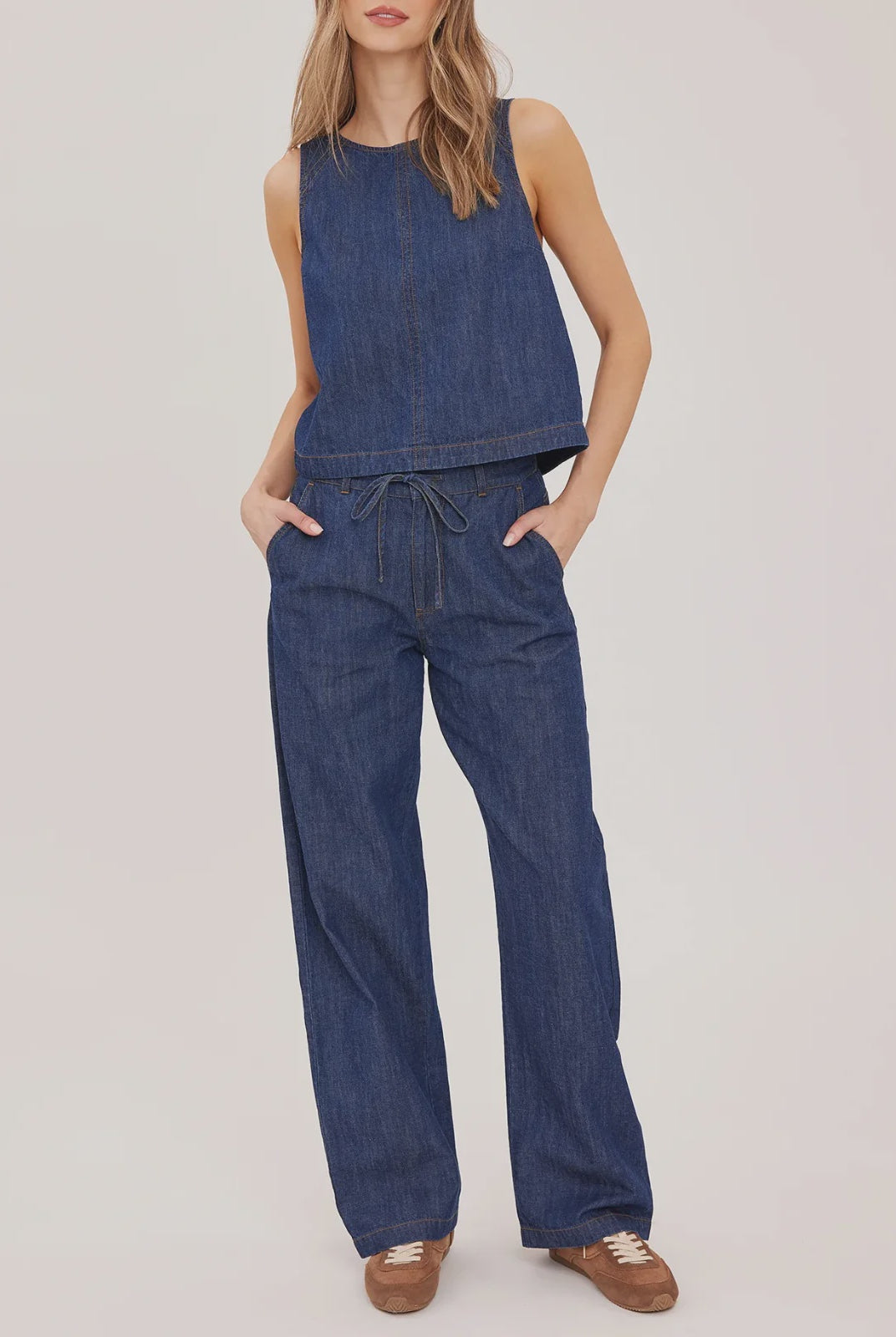 Hayden high-rise barrel-leg pants in washed denim, featuring slash pockets, a front zipper closure, and an elasticated back waistband. Made from a cotton-linen blend for a relaxed, lived-in look.