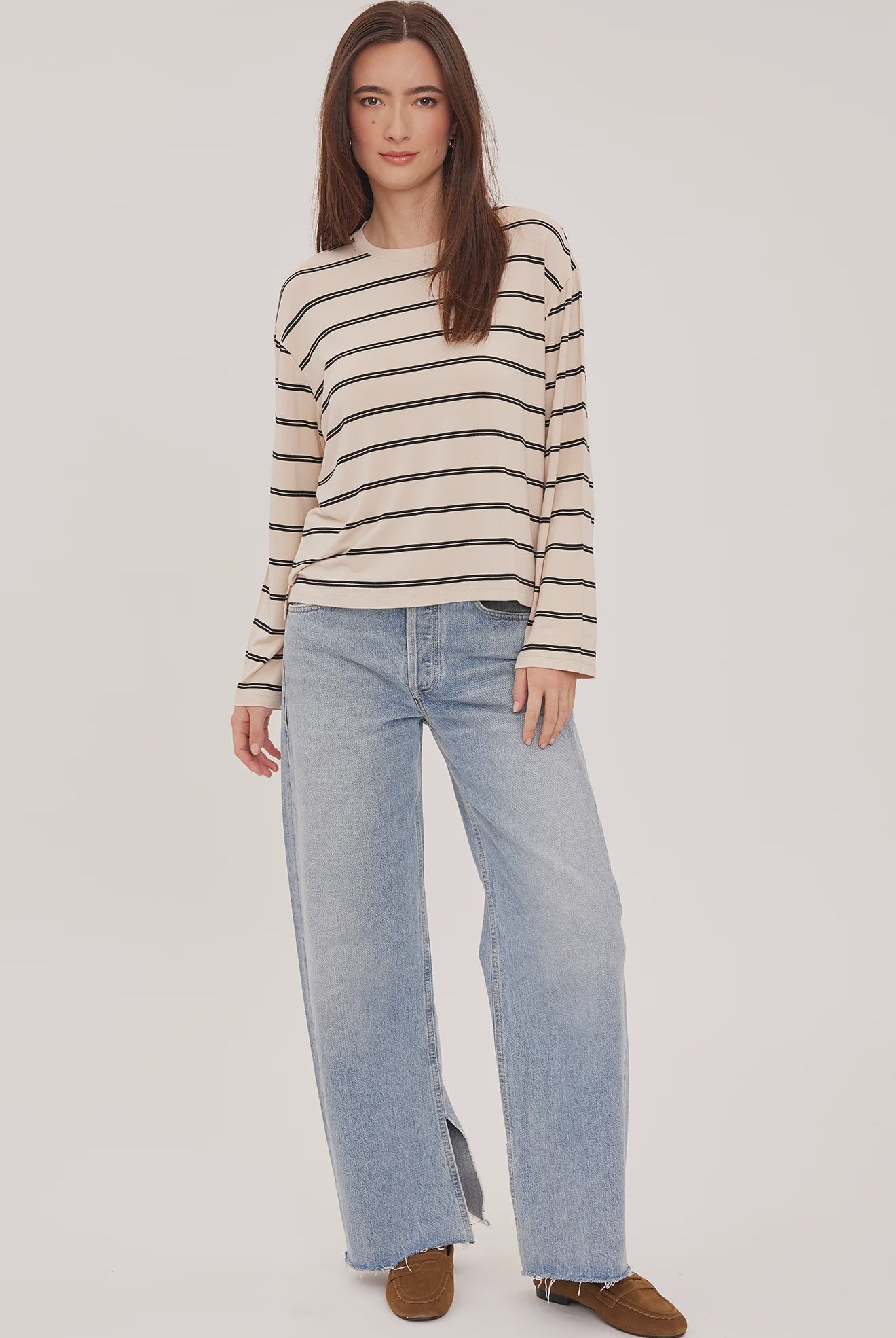 Women's relaxed long sleeve top featuring cream and soft beige stripes, a classic crew neckline, side slits, and a lightweight rayon jersey knit.