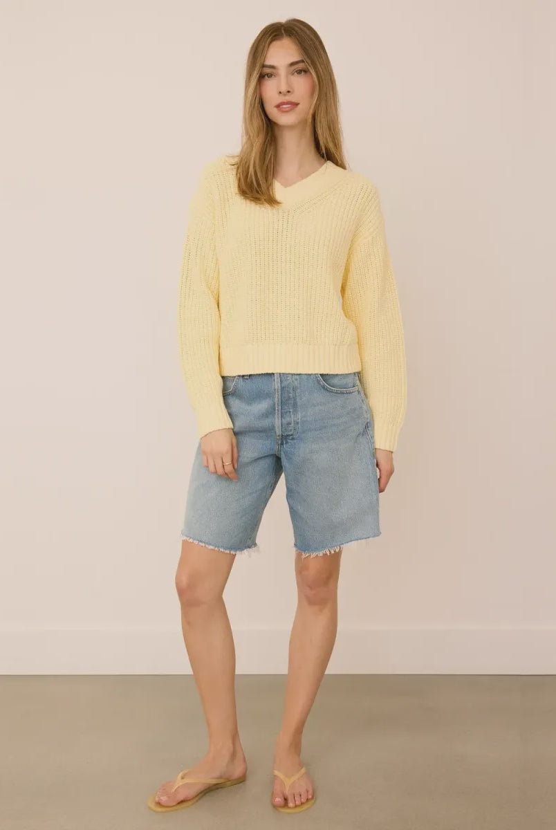 Woman wearing the Gentle Fawn Jocelyn Knit Sweater in Parchment, featuring a soft cotton blend knit, flattering V-neckline, and regular fit.