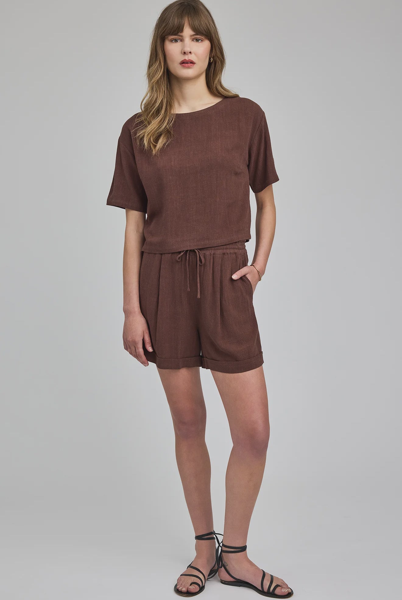 High-rise Juno shorts in a lightweight rayon-linen blend featuring an elastic drawstring waistband, front slash pockets, back patch pockets, and a relaxed fit.