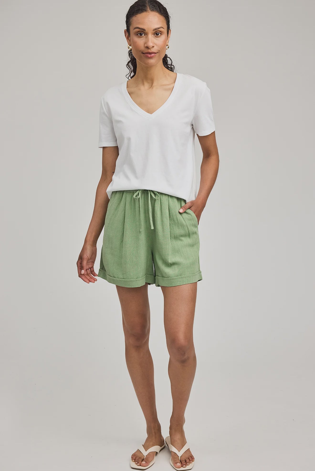 High-rise Juno shorts in a lightweight rayon-linen blend featuring an elastic drawstring waistband, front slash pockets, back patch pockets, and a relaxed fit.