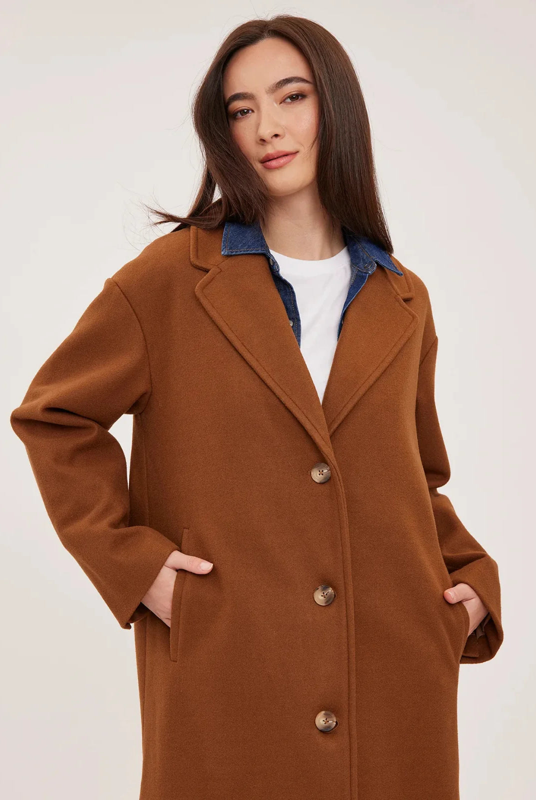 Agatha coat in soft, brushed melton fabric, featuring a front button closure, welt pockets, side slits, and a fully lined interior.