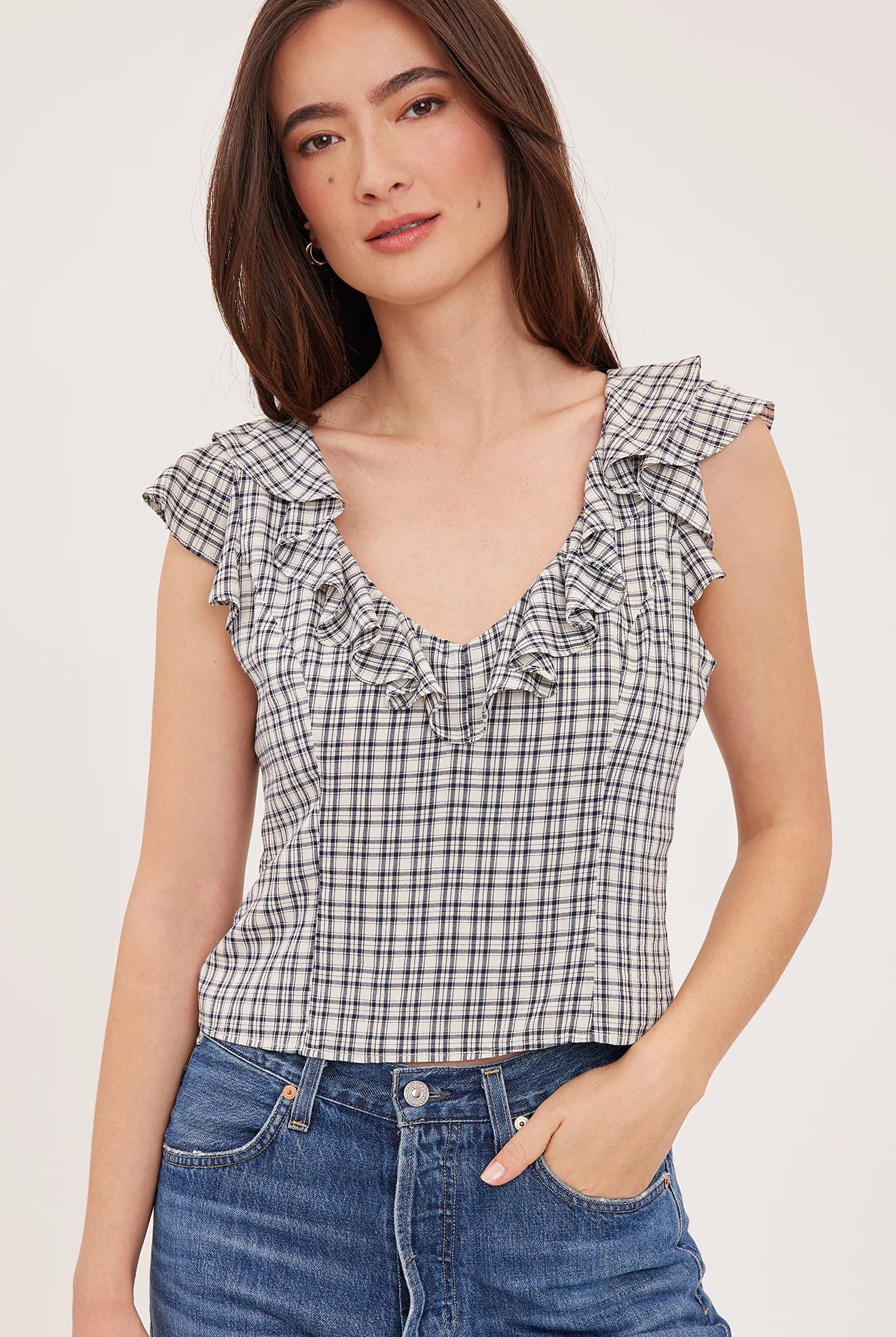 Women's black sleeveless tank top in a lightweight mini check fabric featuring a delicate flounce neckline, a relaxed fit, and a feminine silhouette.