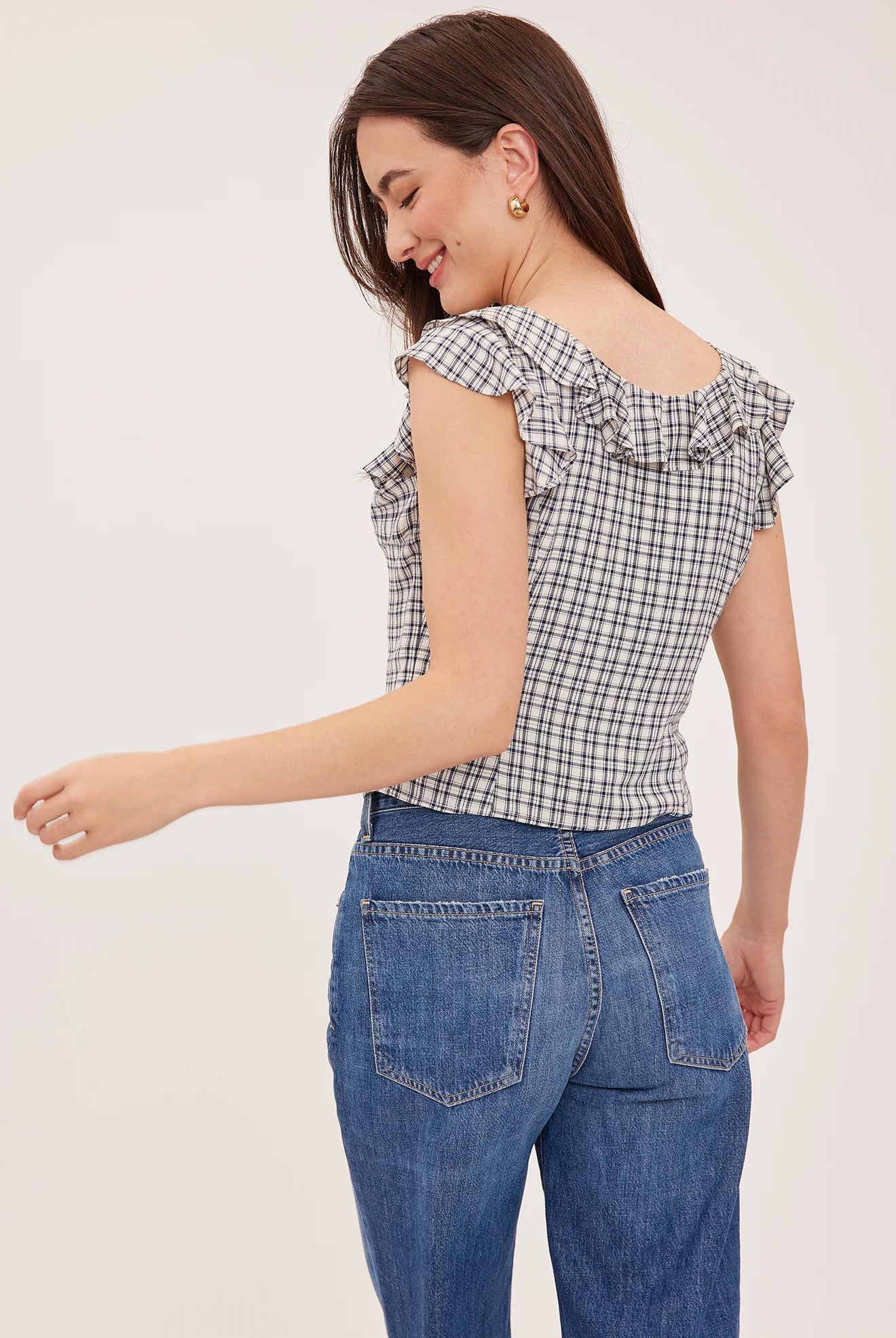 Women's black sleeveless tank top in a lightweight mini check fabric featuring a delicate flounce neckline, a relaxed fit, and a feminine silhouette.