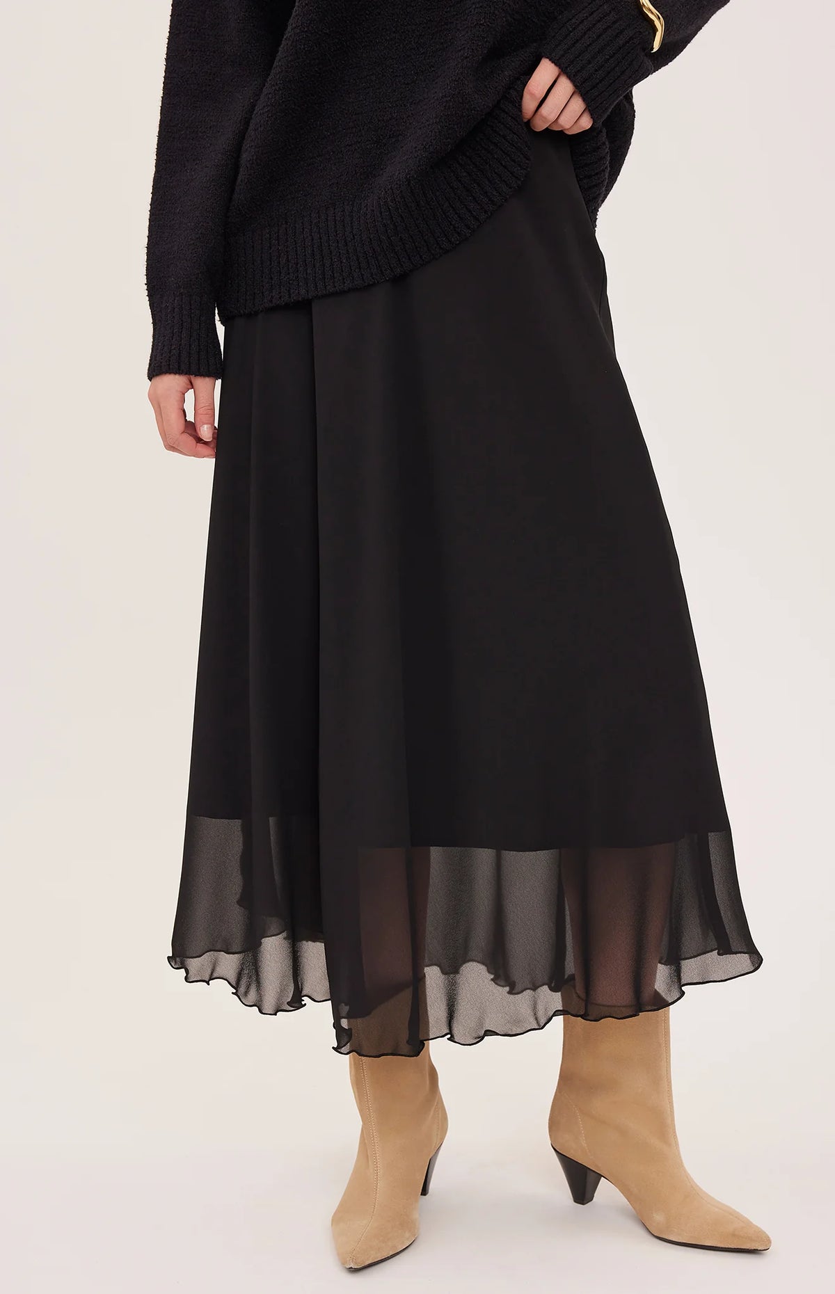 Arianna bias-cut chiffon skirt with a flattering high-rise fit, soft fluid drape, and an elastic waistband finished with delicate scalloped trim. Fully lined for comfortable wear and available in Smoke and Black.