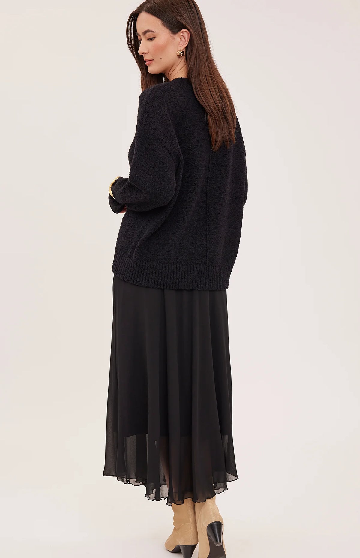 Arianna bias-cut chiffon skirt with a flattering high-rise fit, soft fluid drape, and an elastic waistband finished with delicate scalloped trim. Fully lined for comfortable wear and available in Smoke and Black.