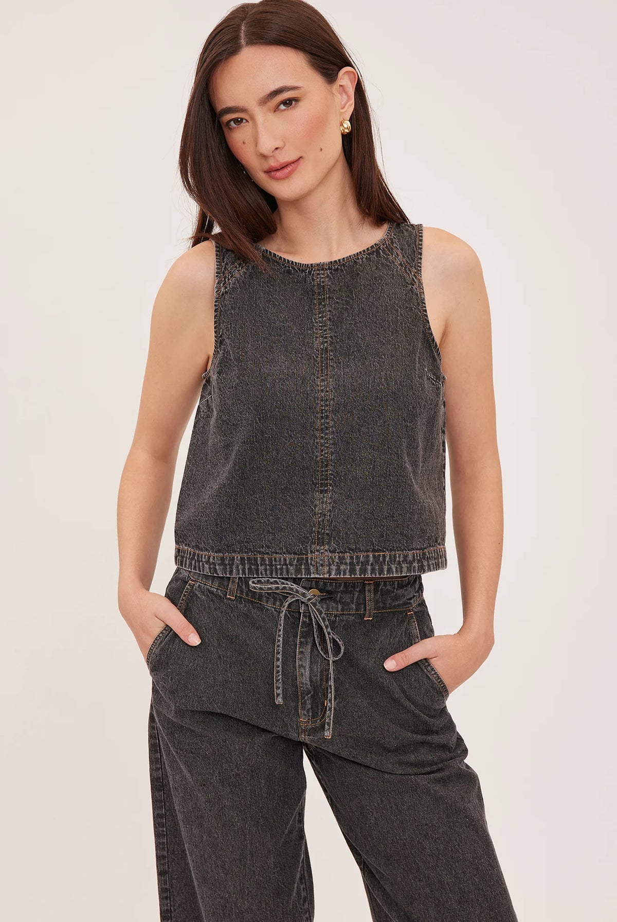 Blaise denim tank top with a lived-in wash, contrast topstitching details, and a back keyhole closure.