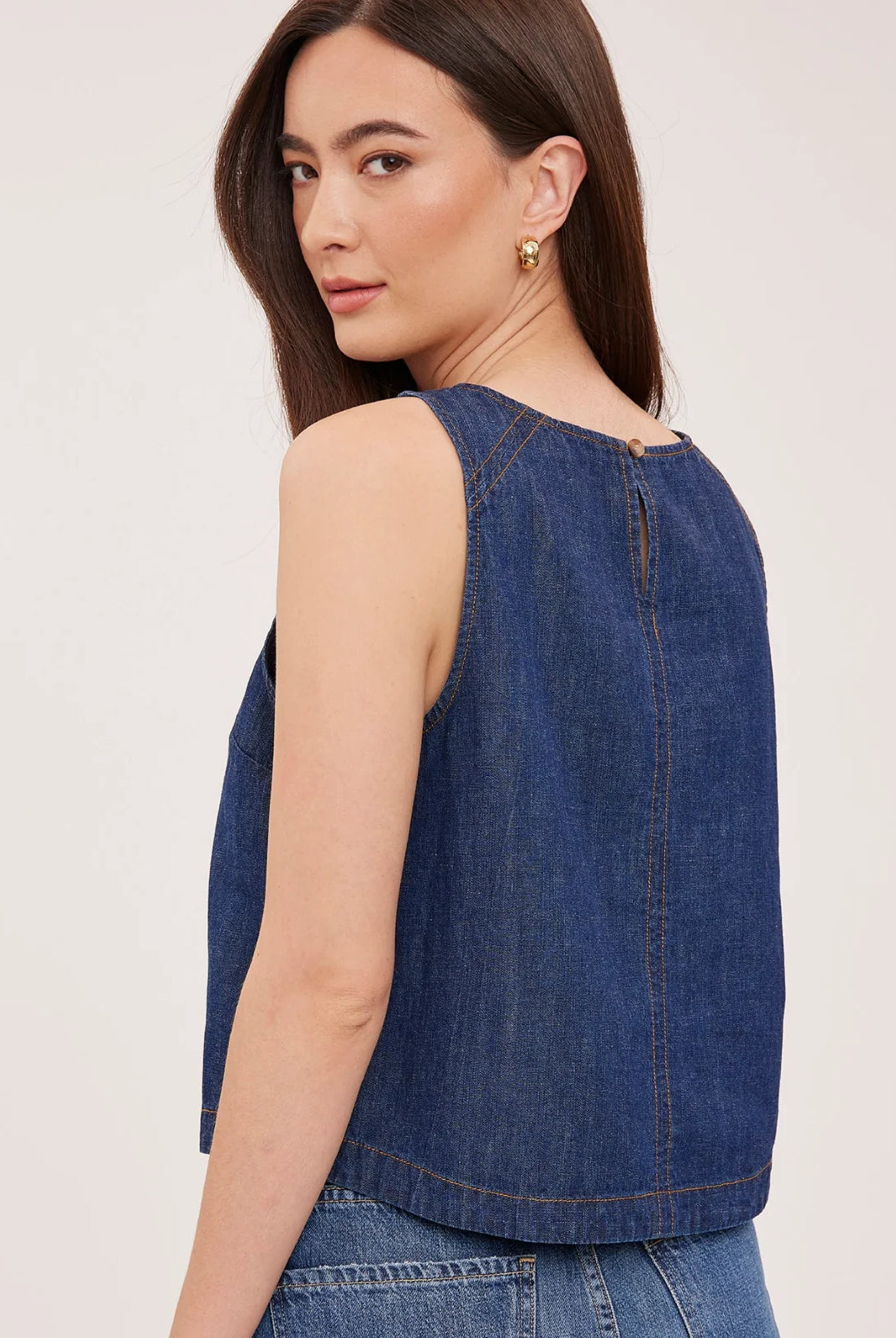 Blaise denim tank top in washed denim with contrast topstitching details and a back keyhole closure, designed for a relaxed, lived-in look.