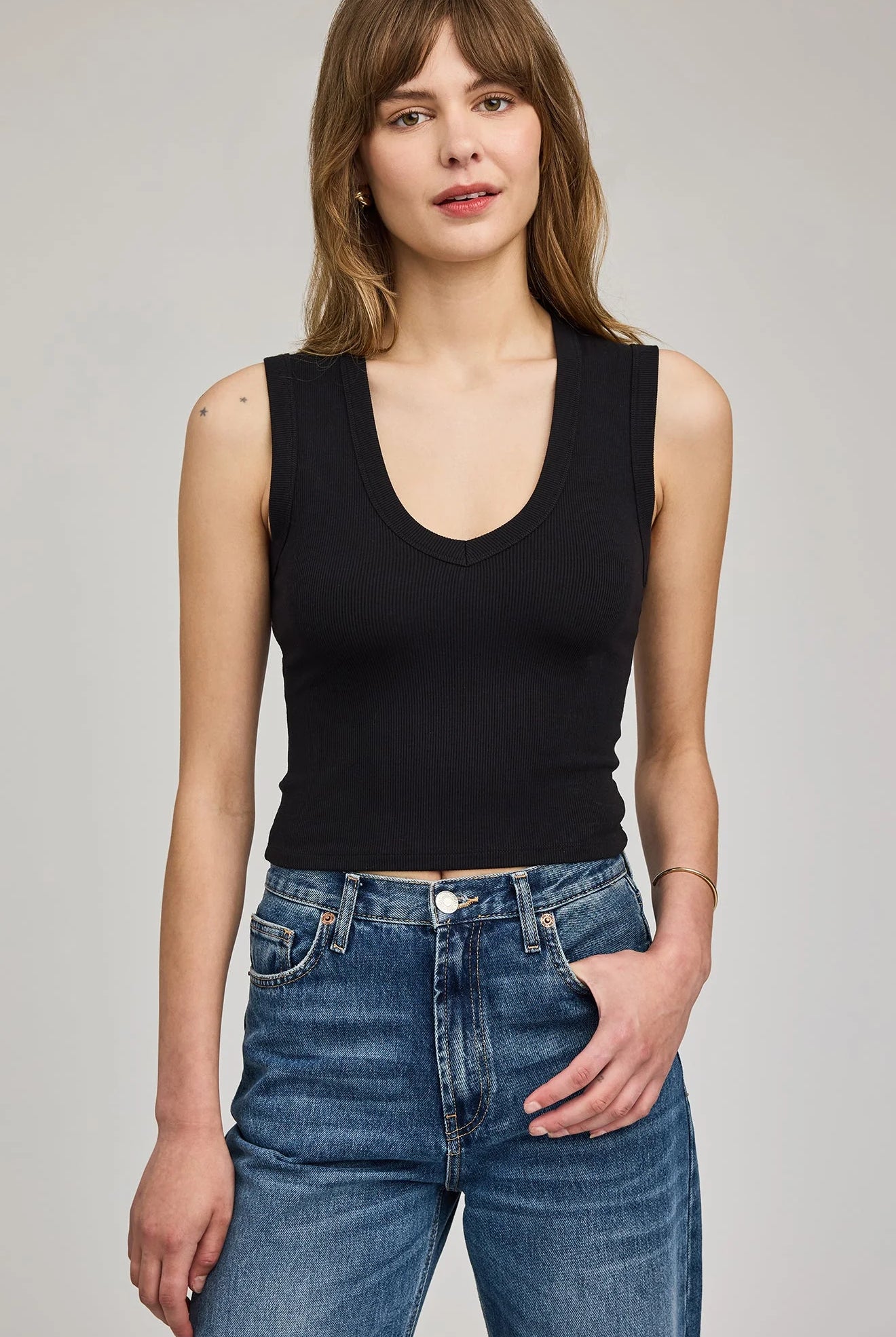 Women's black ribbed cropped tank top featuring a flattering V-neckline, wide straps, and a fitted silhouette in a soft stretch knit.