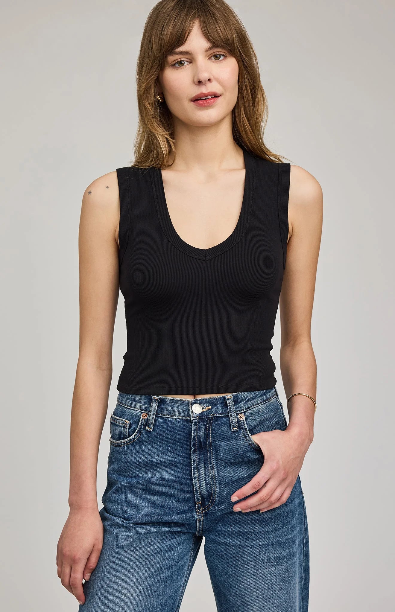 Women's black ribbed cropped tank top featuring a flattering V-neckline, wide straps, and a fitted silhouette in a soft stretch knit.
