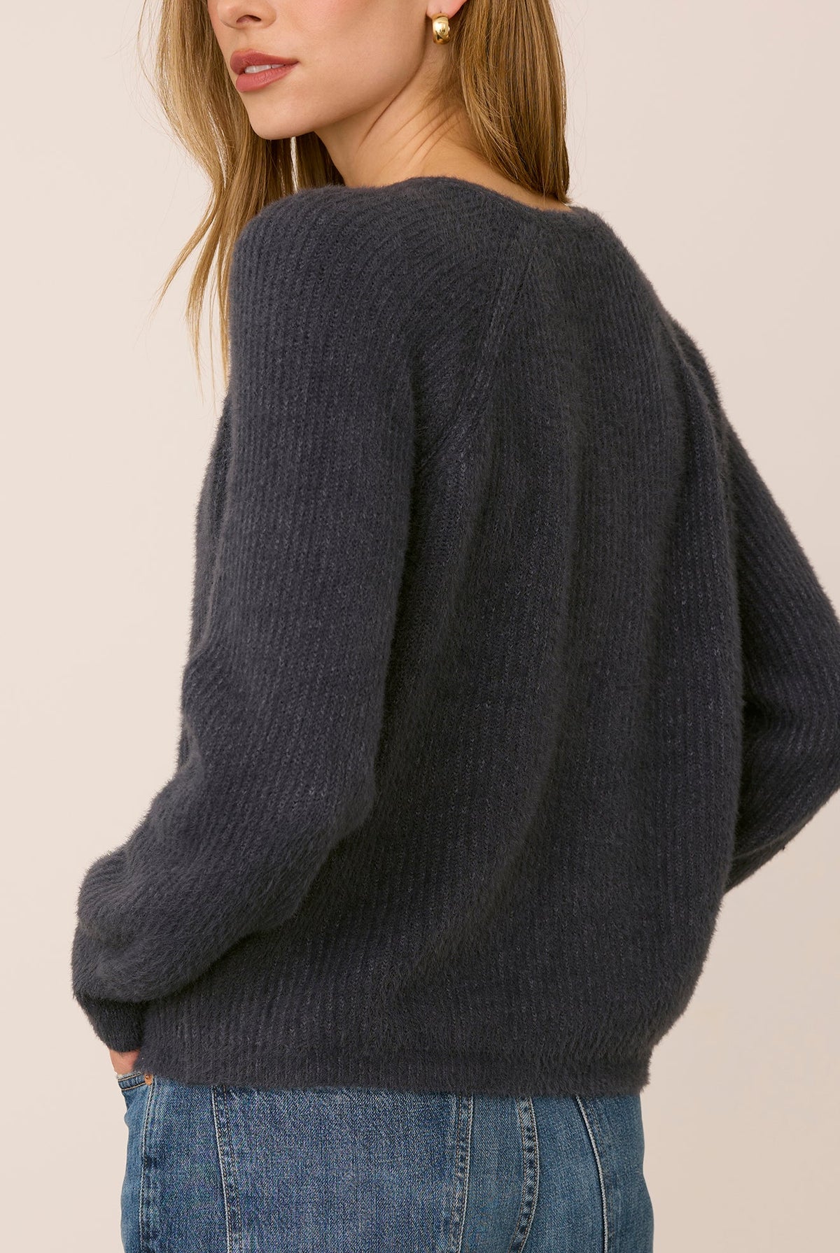 Filomena sweater in a soft, plush knit with a relaxed silhouette, flattering V-neckline, and raglan sleeves for an easy, laid-back fit. Available in Smoke and Skyline.