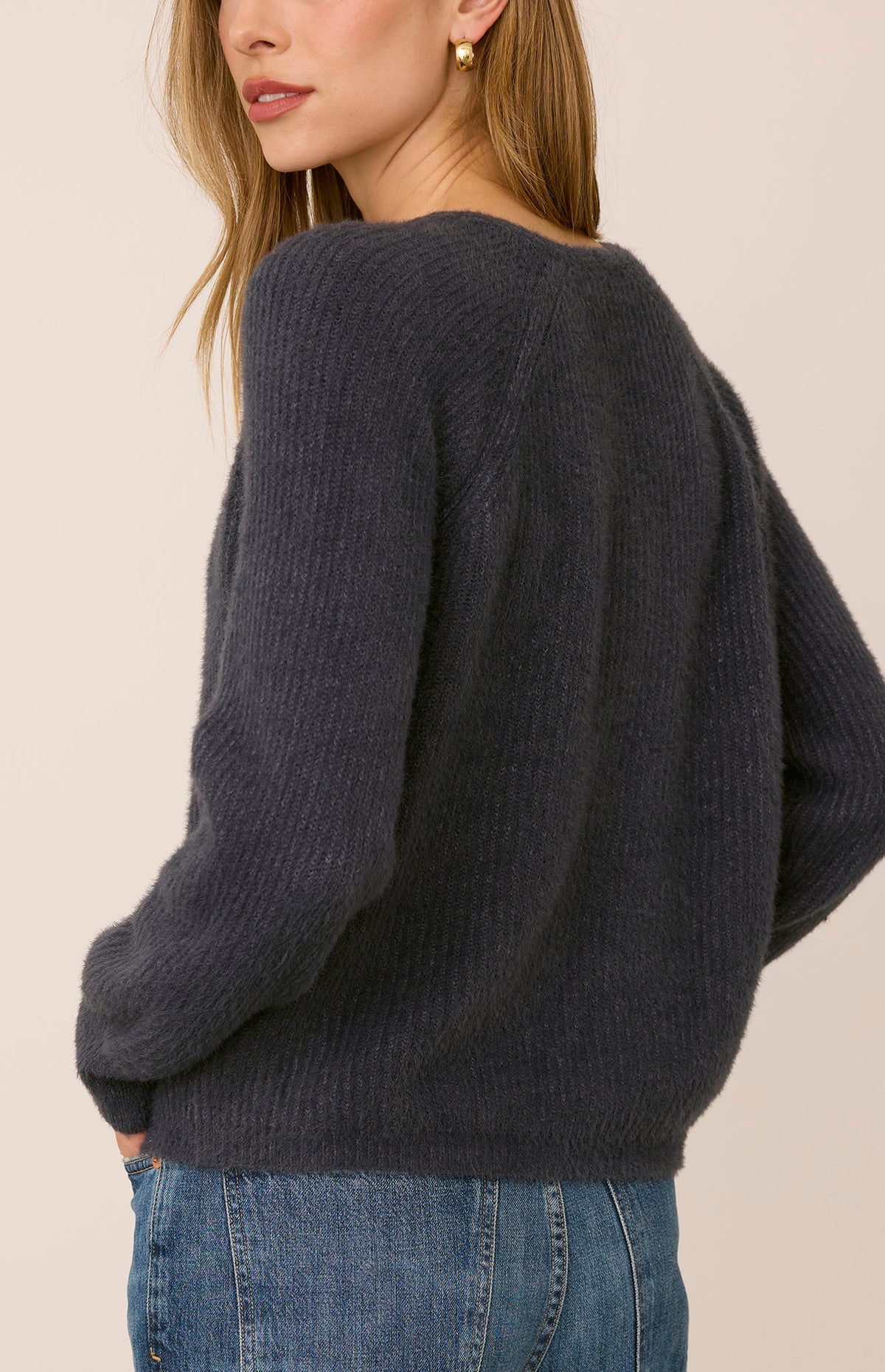 Filomena sweater in a soft, plush knit with a relaxed silhouette, flattering V-neckline, and raglan sleeves for an easy, laid-back fit. Available in Smoke and Skyline.