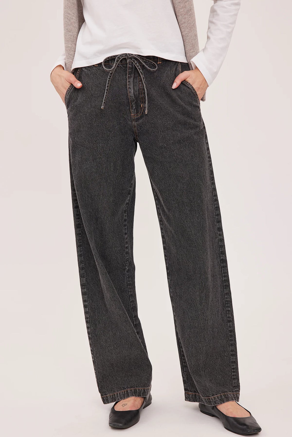 Hayden high-rise barrel-leg pants in washed denim, featuring slash pockets, a front zipper closure, and an elasticated back waistband. Made from a cotton-linen blend for a relaxed, lived-in look.