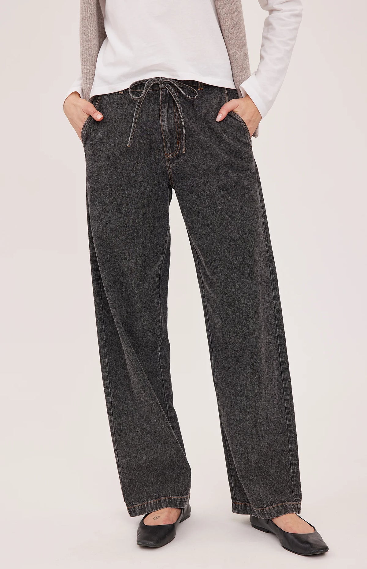 Hayden high-rise barrel-leg pants in washed denim, featuring slash pockets, a front zipper closure, and an elasticated back waistband. Made from a cotton-linen blend for a relaxed, lived-in look.