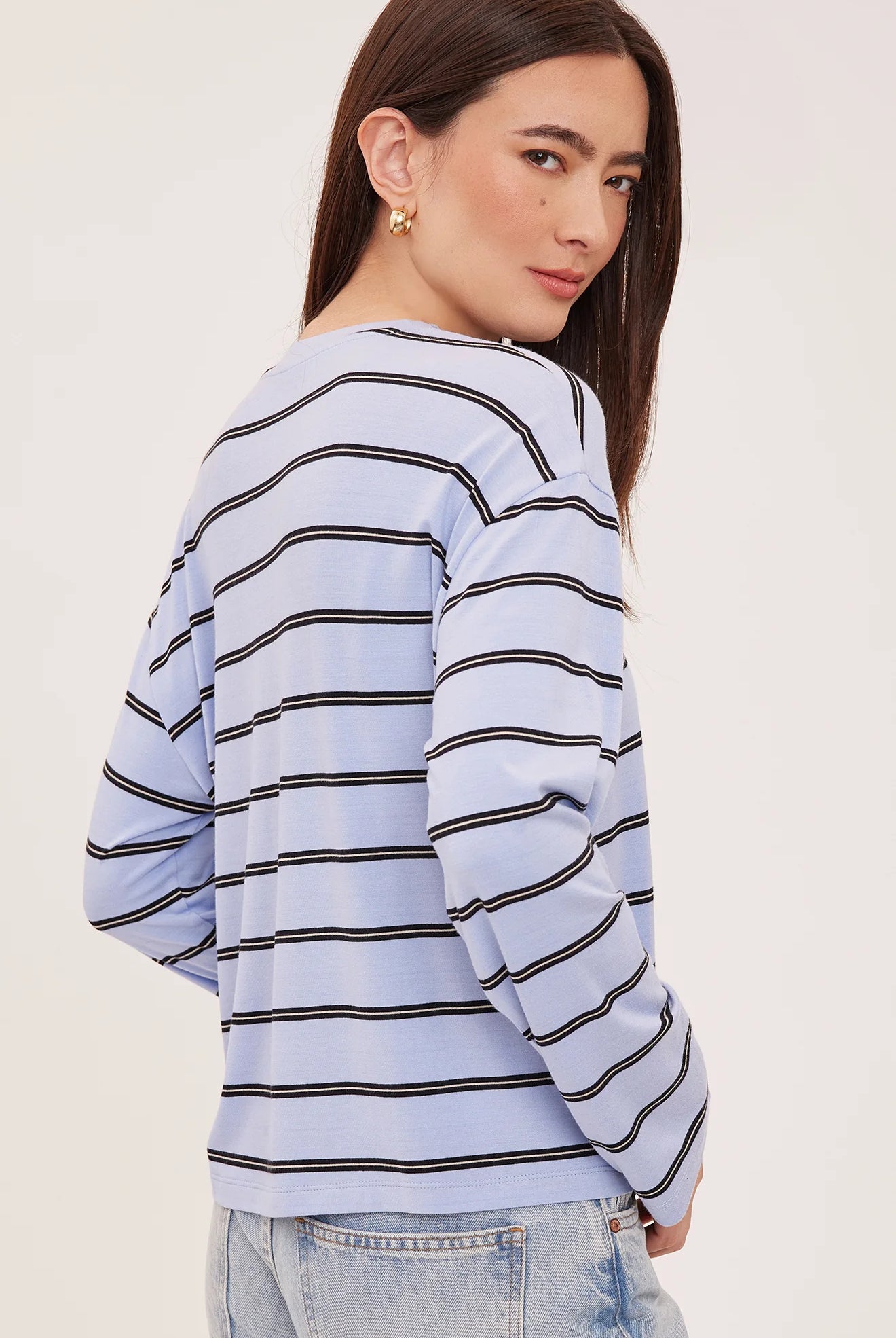 Women's relaxed long sleeve top with sky blue and white stripes, a crew neckline, side slits, and a soft rayon jersey fabric
