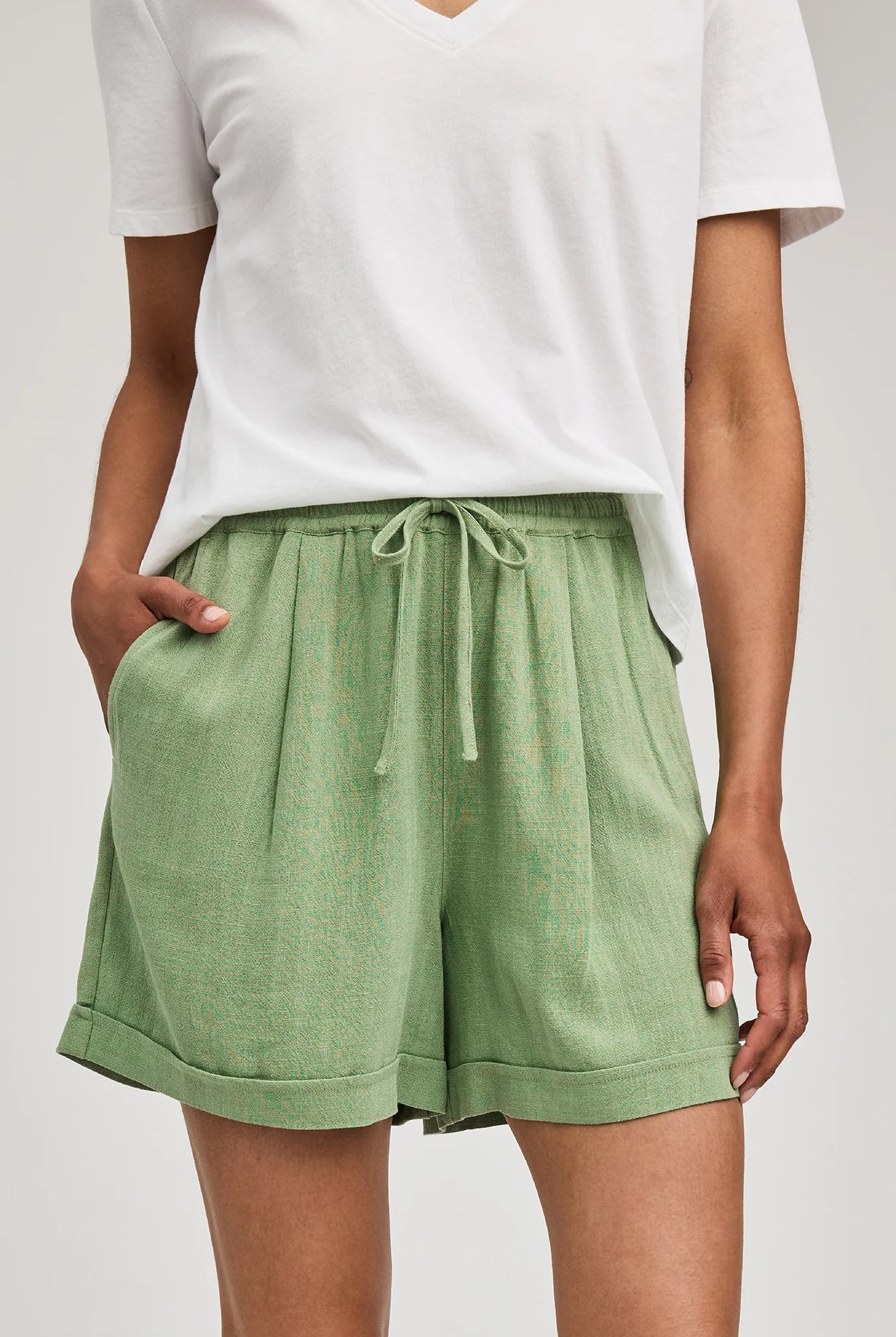High-rise Juno shorts in a lightweight rayon-linen blend featuring an elastic drawstring waistband, front slash pockets, back patch pockets, and a relaxed fit.