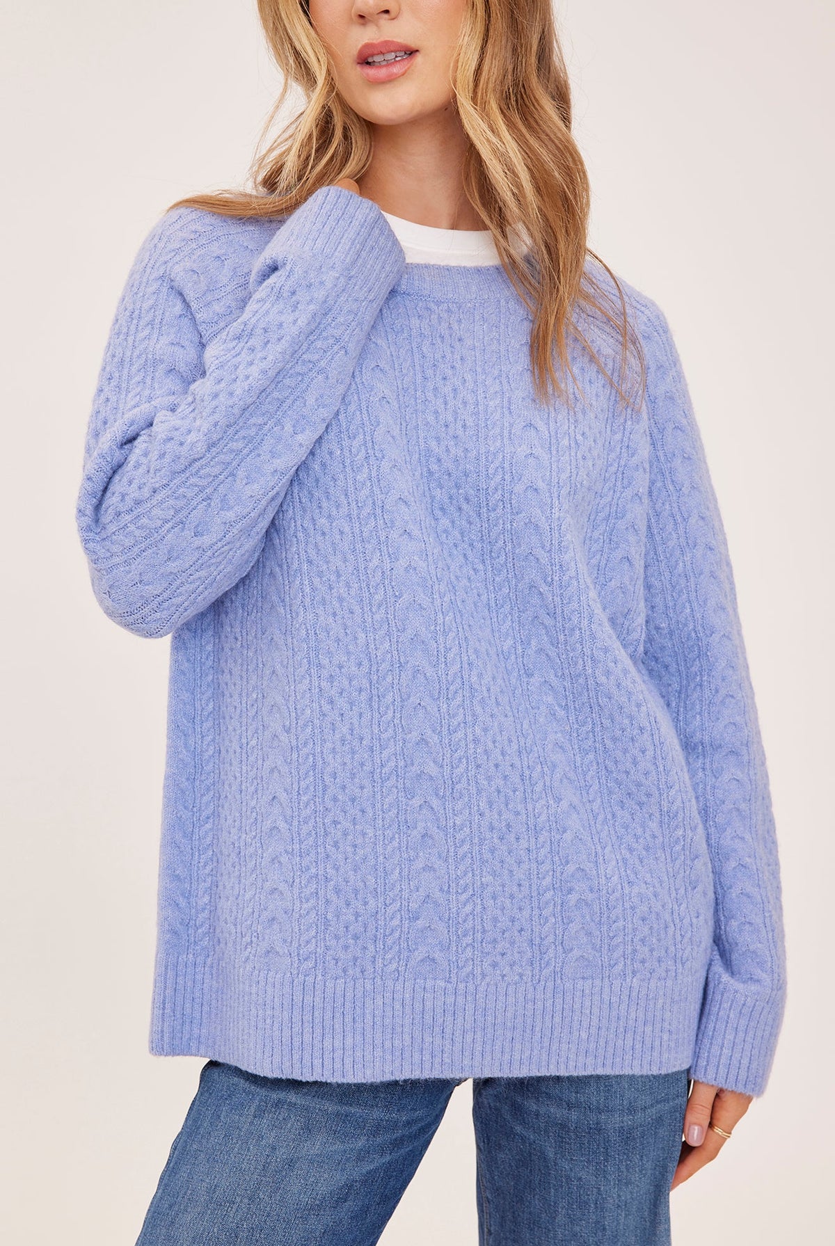 Lori sweater in a cozy heathered knit with a classic crew neckline, oversized fit, and allover cable knit detailing for a textured finish.